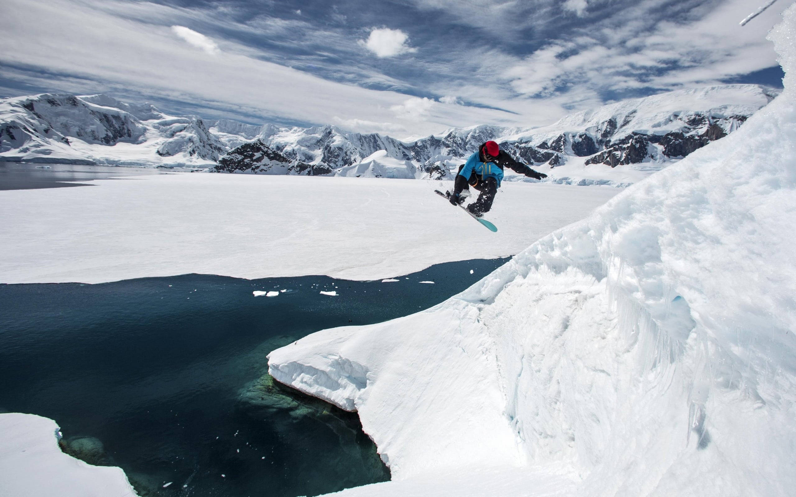 snowboarder, snowy cliff, deep blue glacial sea, 2K Desktop Wallpaper