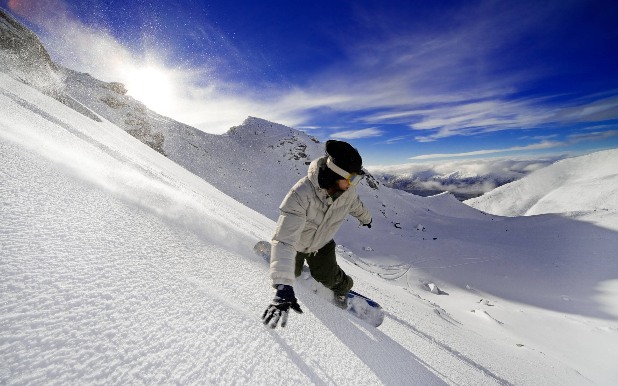 snowboarder, steep snowy mountain slope, bright blue sky, 2K Desktop Wallpaper