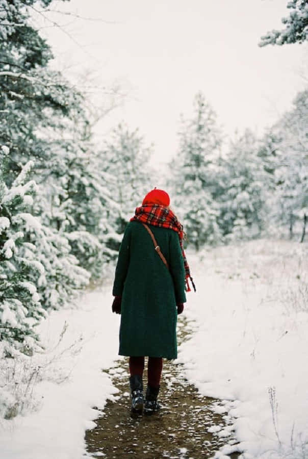 Snowshoes, green coat, red hat, SD Phone Wallpaper
