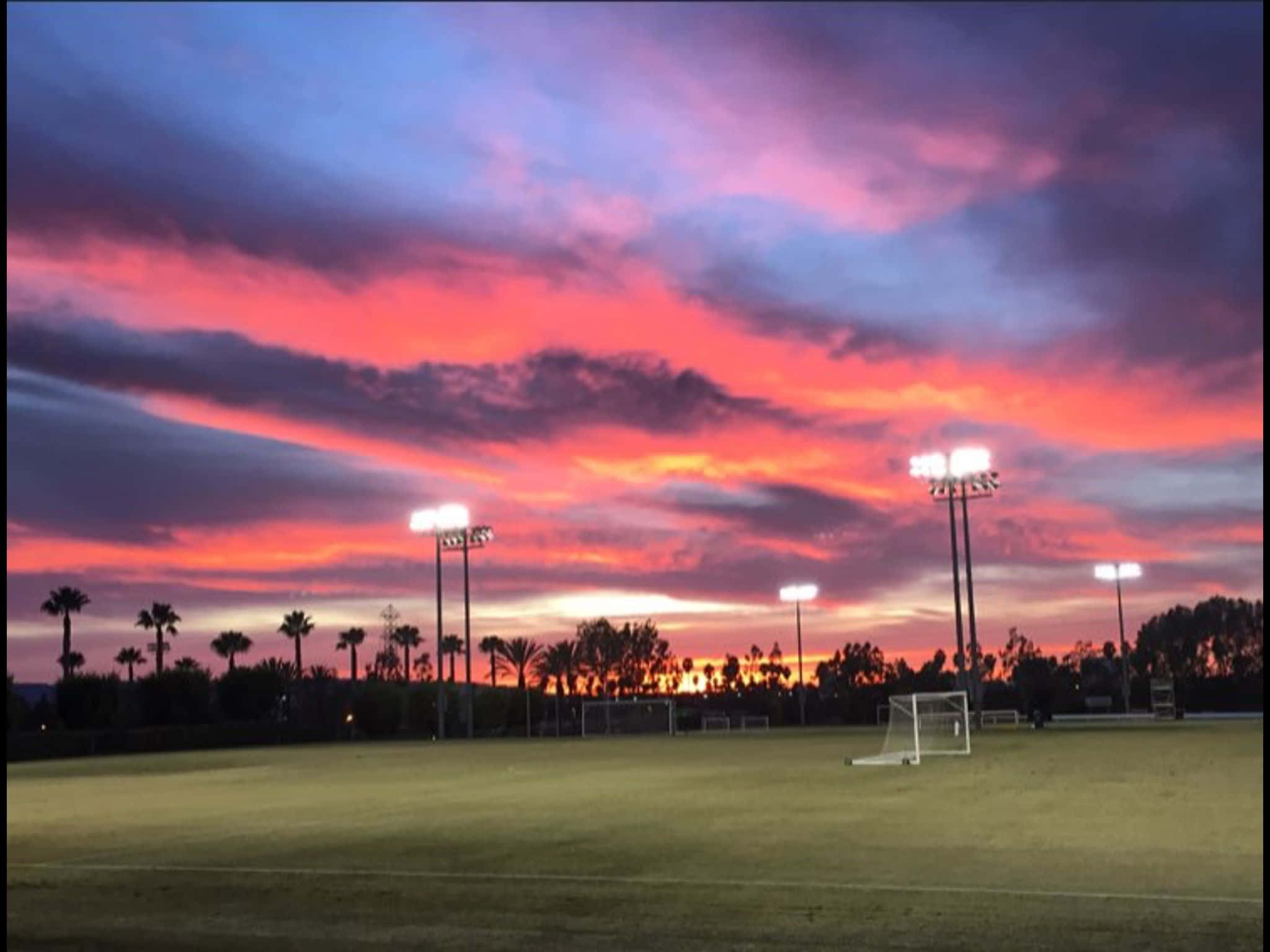 soccer field, dusk, vibrant pink purple and orange sky, Full HD Desktop Wallpaper