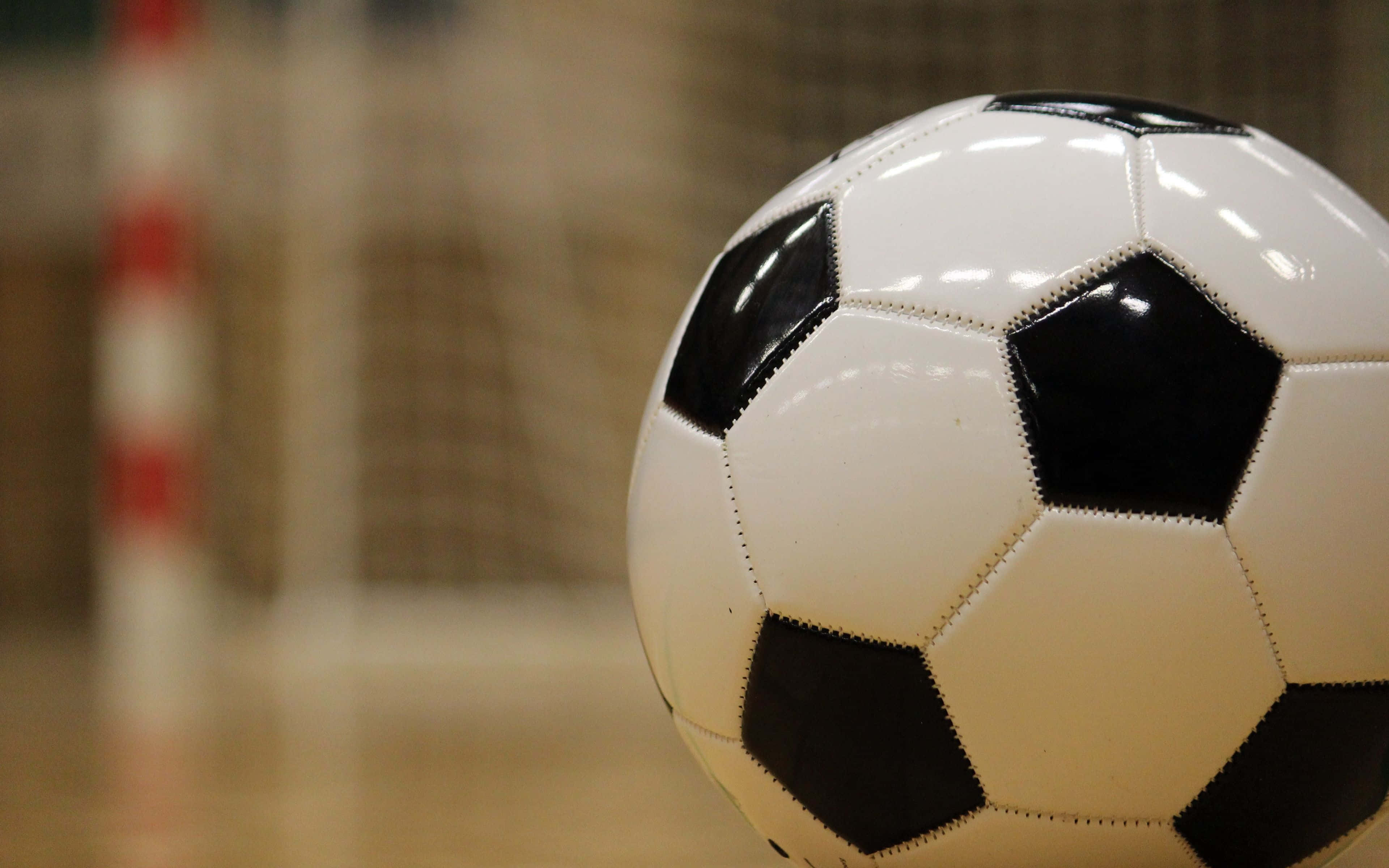 classic black and white soccer ball, indoor goal net, close-up, 4K Desktop Wallpaper