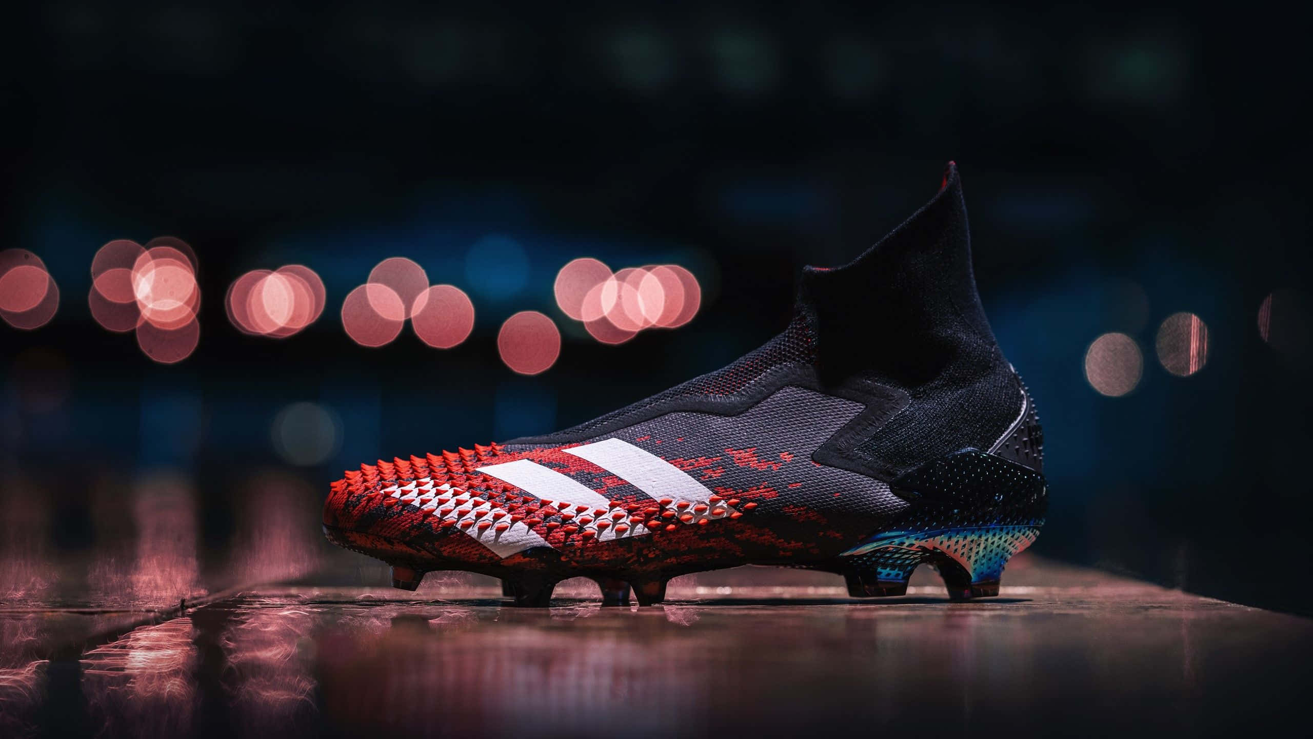 sleek black and red football boot, white stripes, wet surface, 2K Desktop Wallpaper