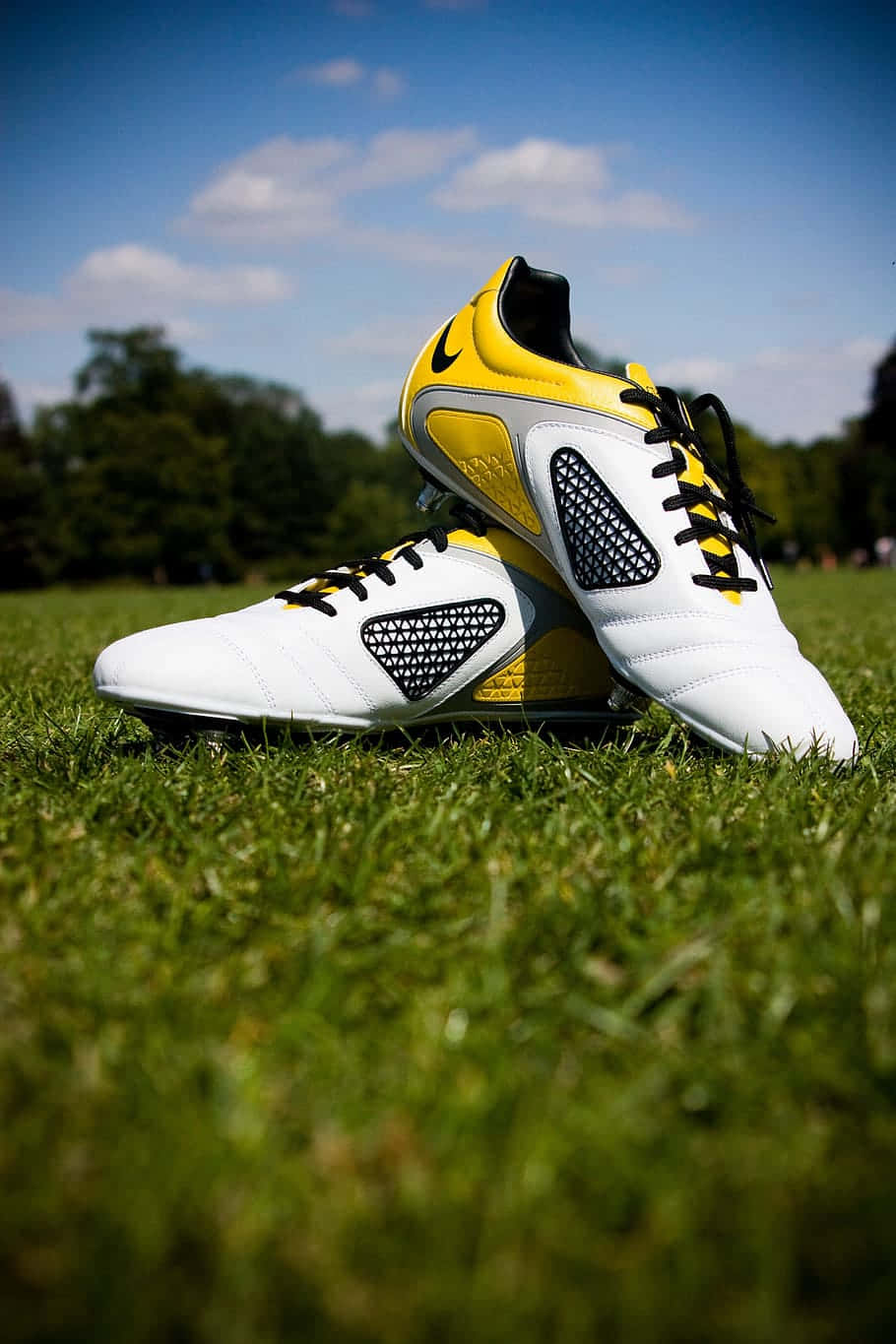 white and yellow soccer cleats, vibrant green grass, bright blue sky, HD Phone Wallpaper