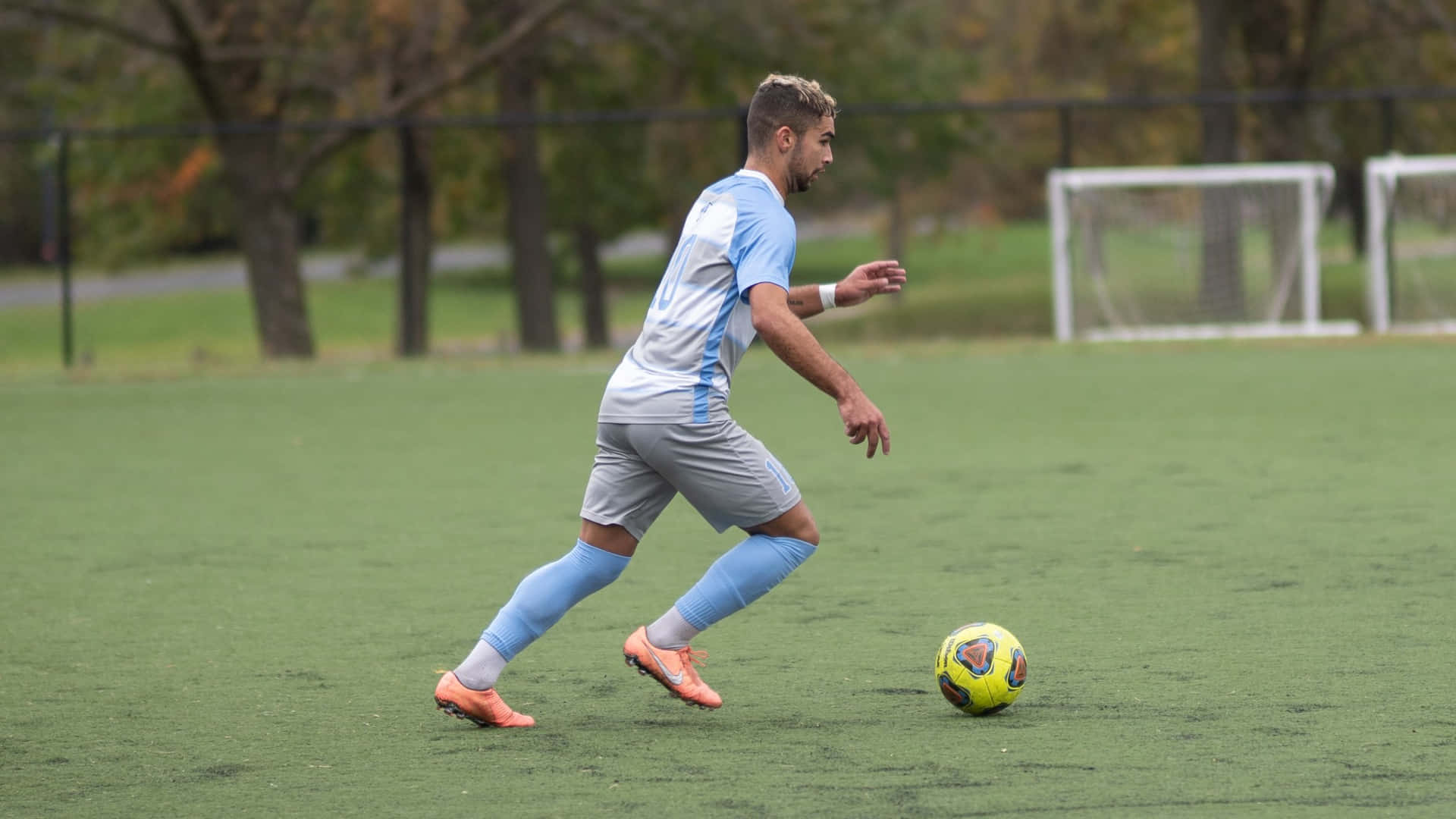 soccer player, light blue and gray uniform, bright yellow ball, Full HD Desktop Wallpaper