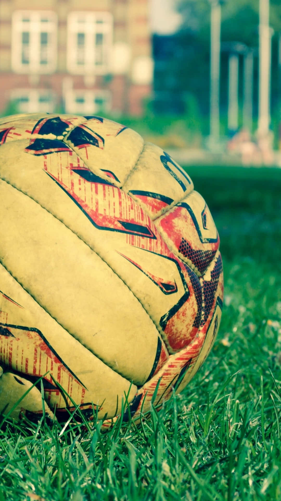 soccer ball, red black and yellow patterns, vibrant green grass, Full HD Phone Wallpaper