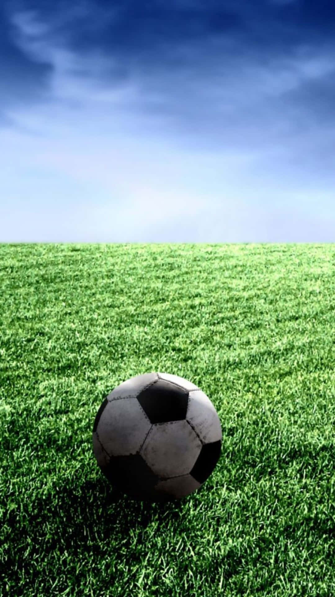 black and white soccer ball, vibrant green grass, vast blue sky, Full HD Phone Wallpaper