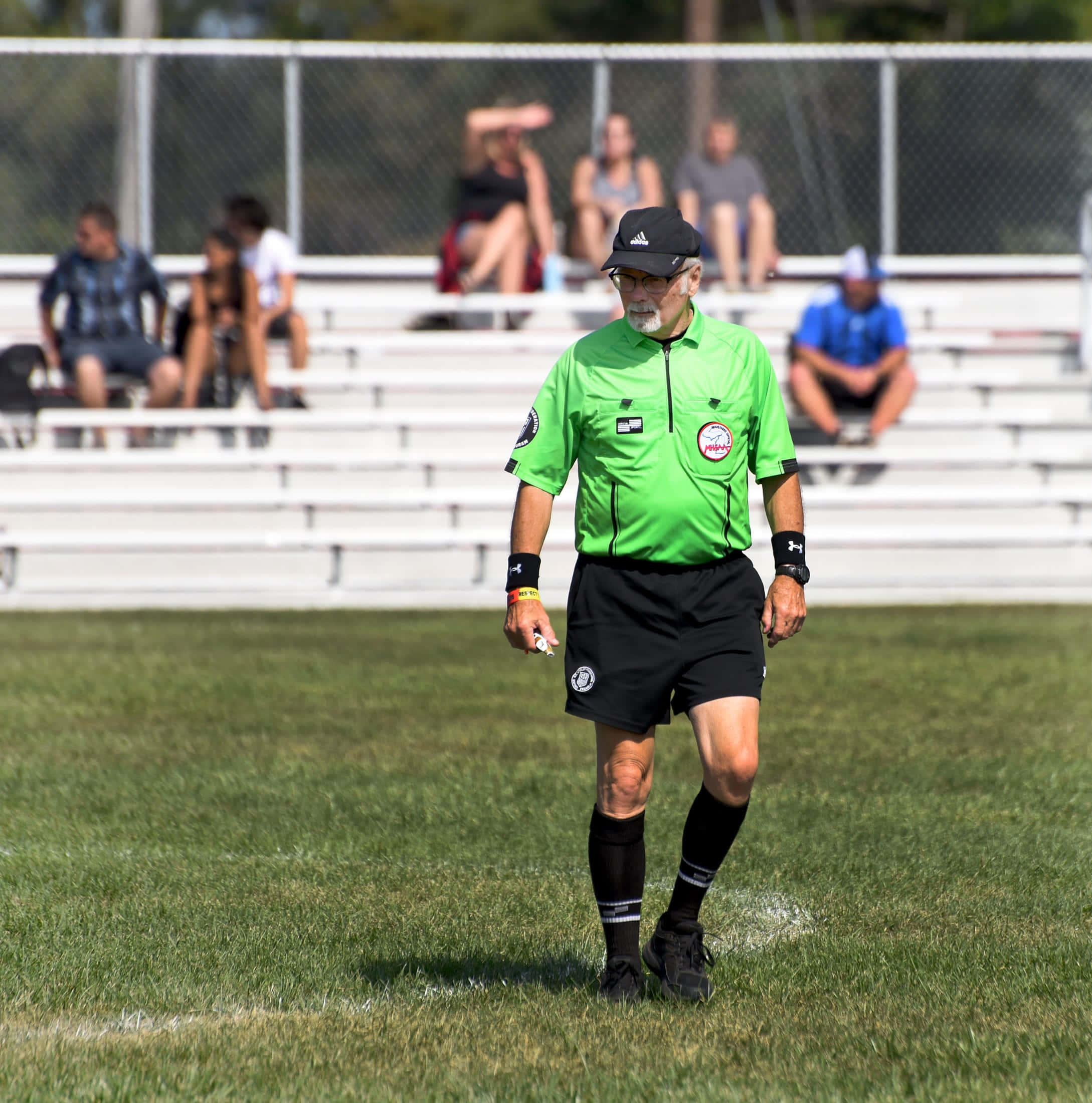 soccer referee, bright green jersey, sunlit grass field, Full HD Phone Wallpaper