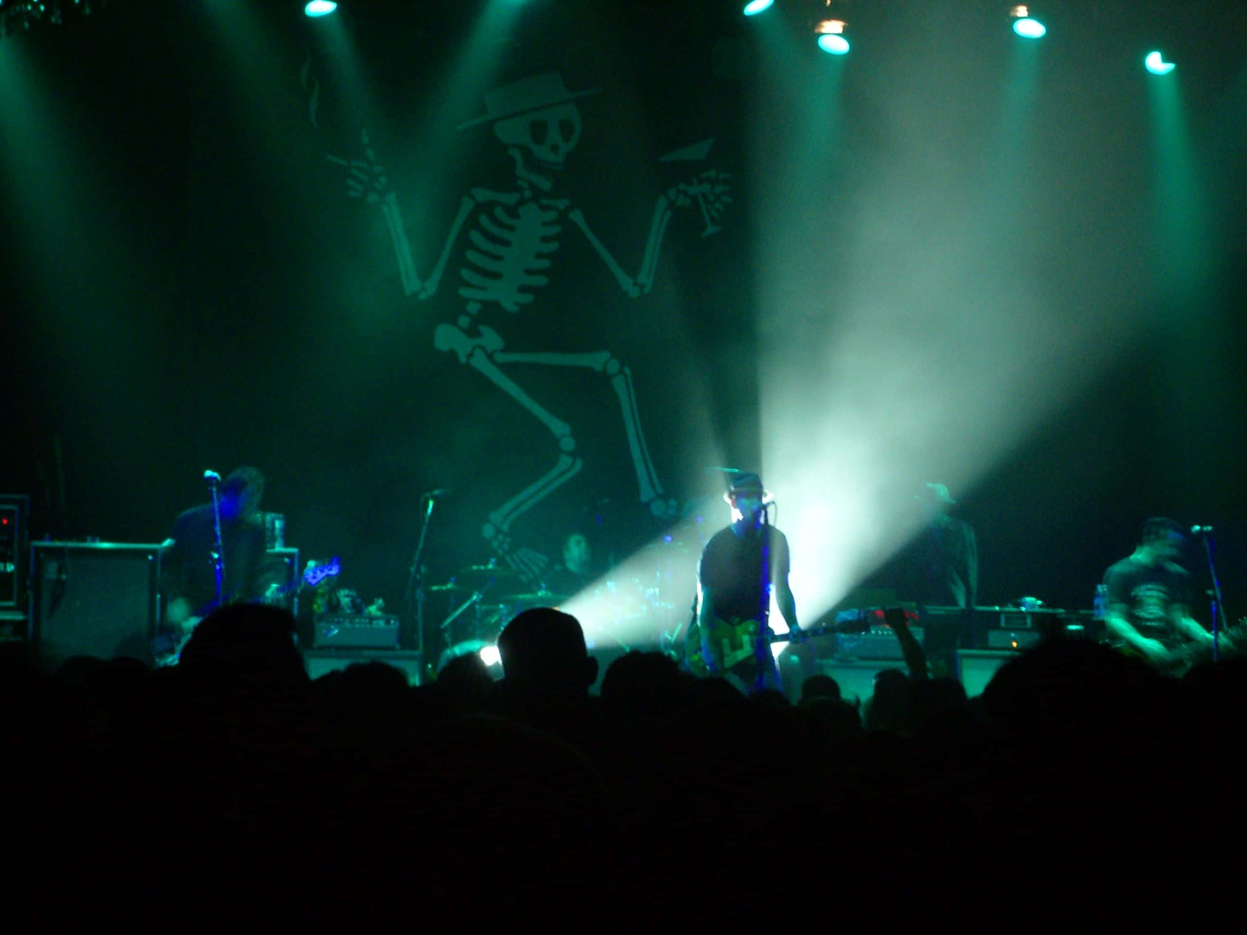 Social Distortion, green light, giant dancing skeleton projection, 2K Desktop Wallpaper