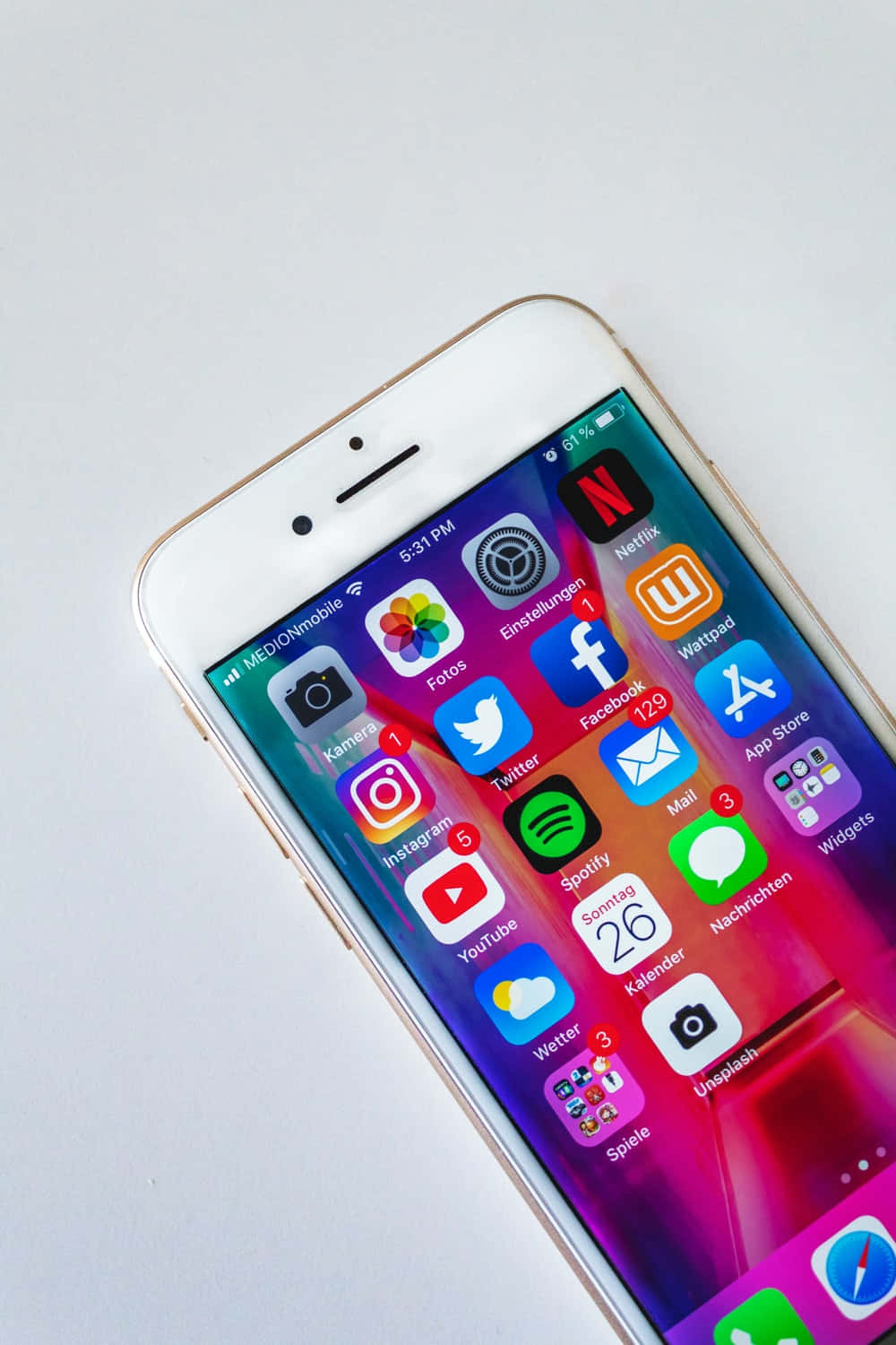 gold iPhone, colorful app grid, vibrant gradient wallpaper, HD Phone Wallpaper