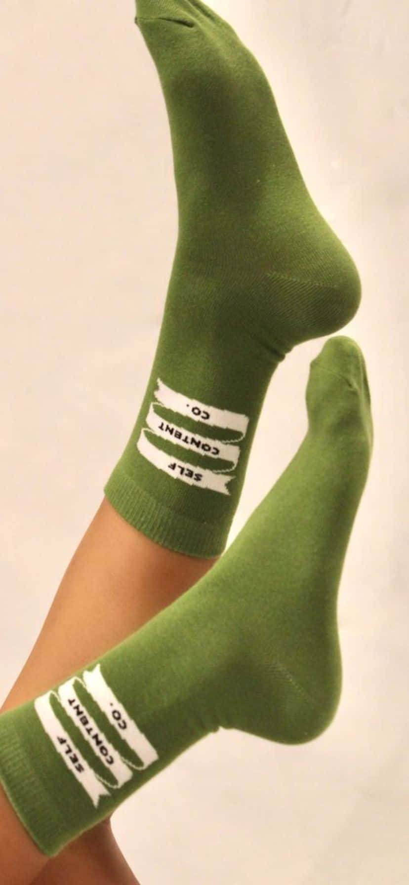olive green socks, white 'SELF CONTENT CO.' text design, close-up of legs, HD Phone Wallpaper