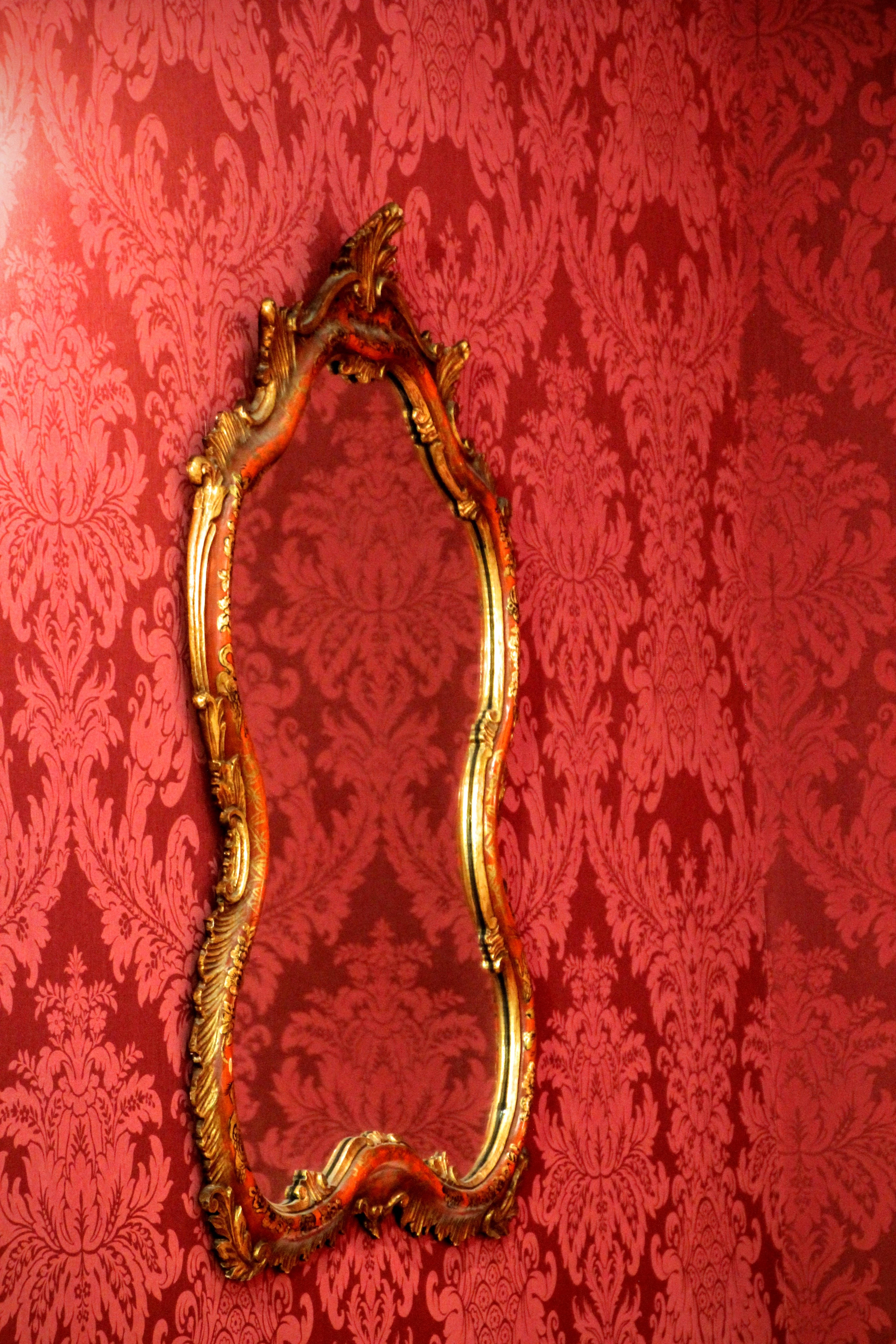 gold-framed mirror, rich red damask wallpaper, intricate floral patterns, 5K Phone Wallpaper