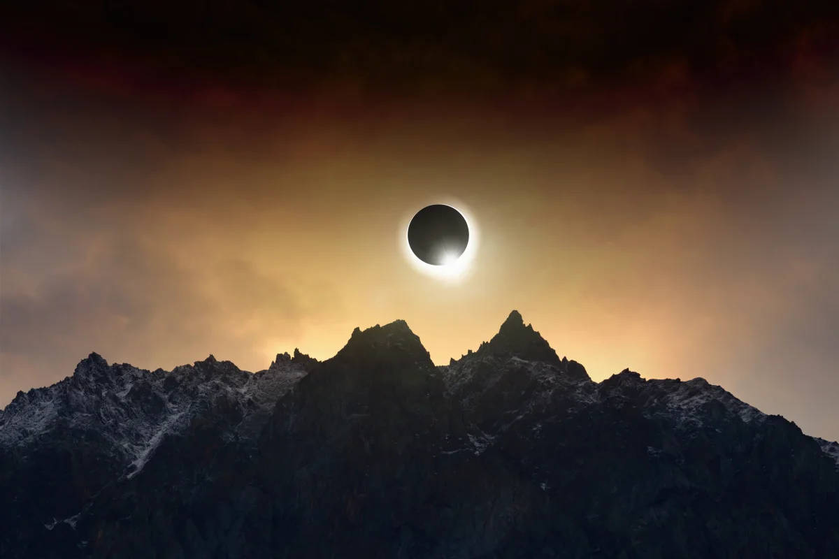 solar eclipse, cloudy mountaintop, jagged snow-capped mountain range, SD Desktop Wallpaper