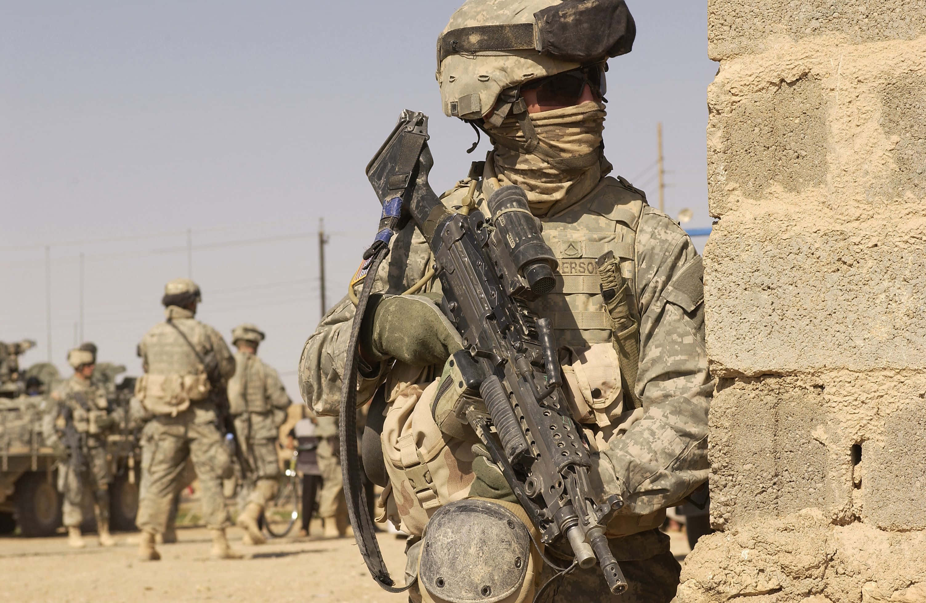 soldier, full combat gear, weathered stone wall, 2K Desktop Wallpaper