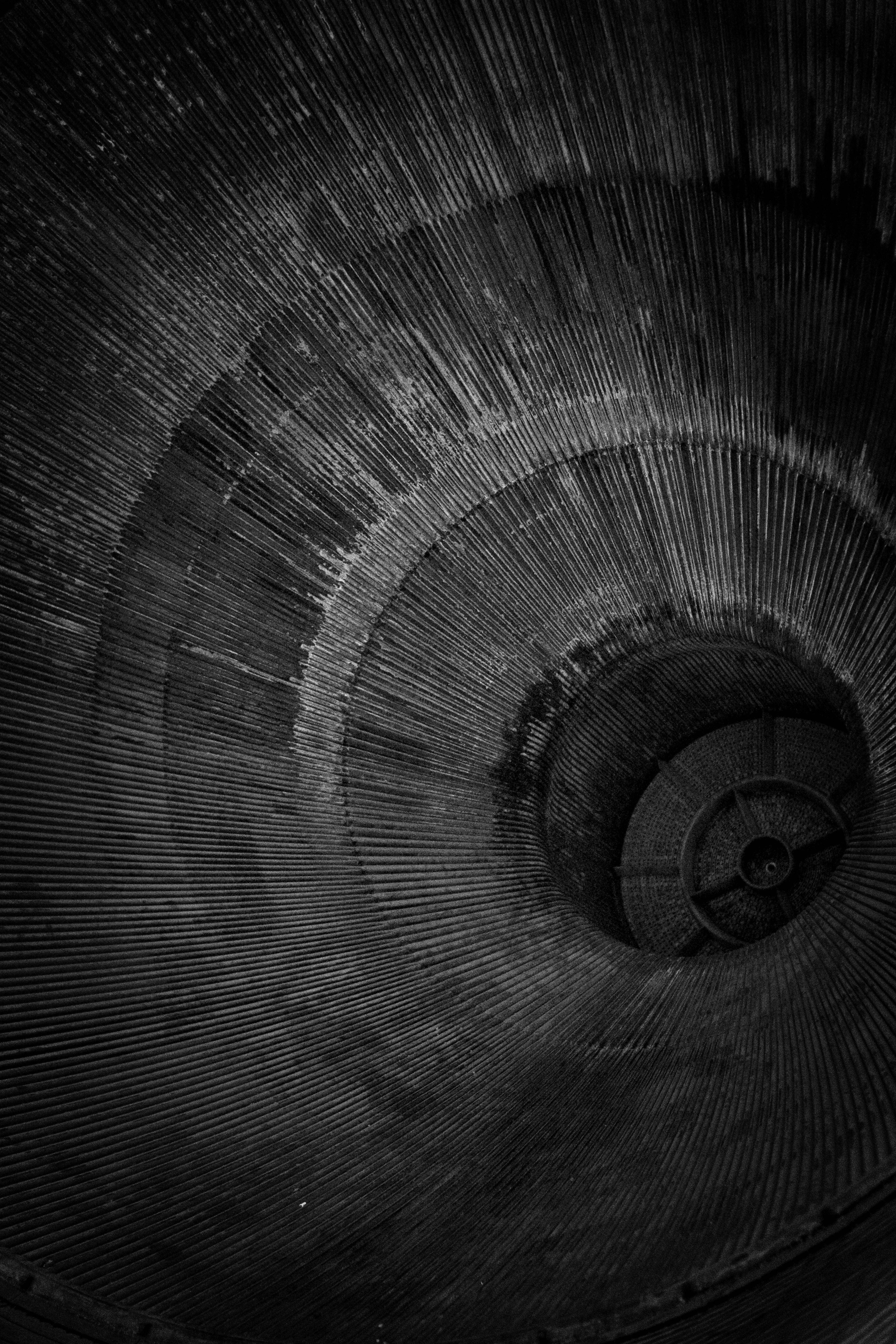 solid black iPhone, spiral staircase, textured concrete walls, 5K Phone Wallpaper
