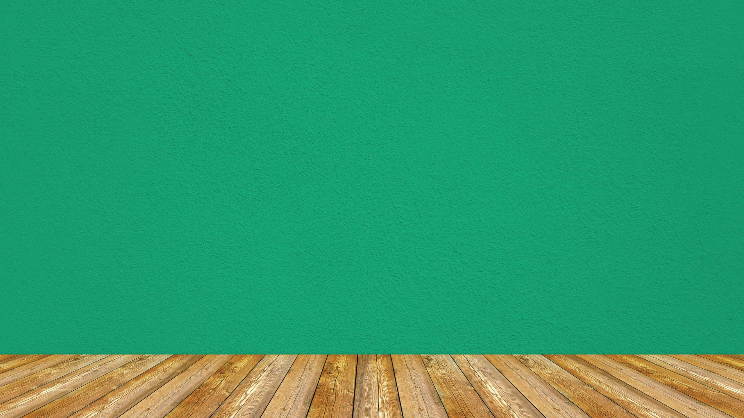 Solid Green, textured teal wall, warm wooden floorboards, 2K Desktop Wallpaper