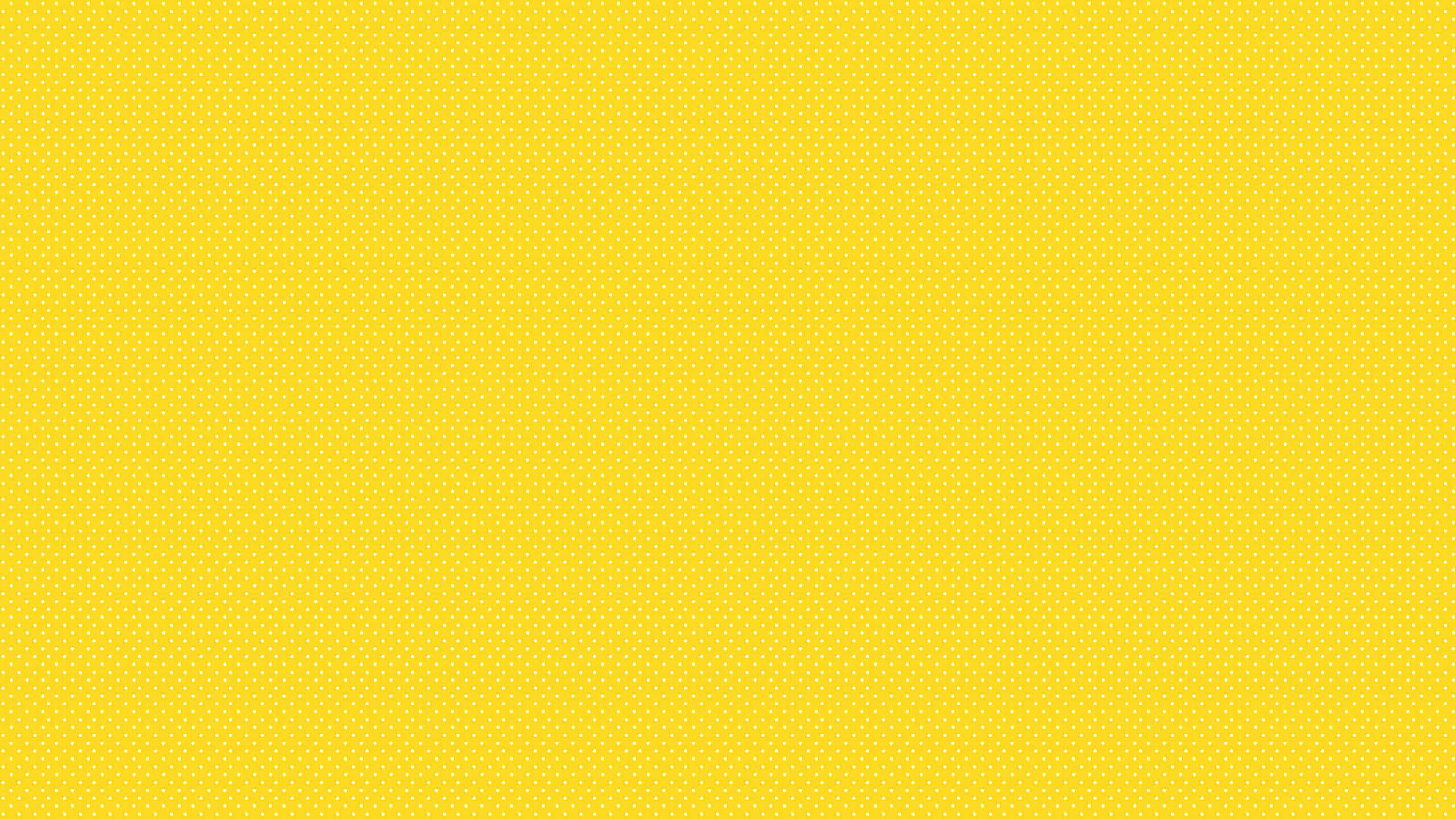 Solid Yellow, vibrant yellow, subtle repeating dot pattern, 2K Desktop Wallpaper