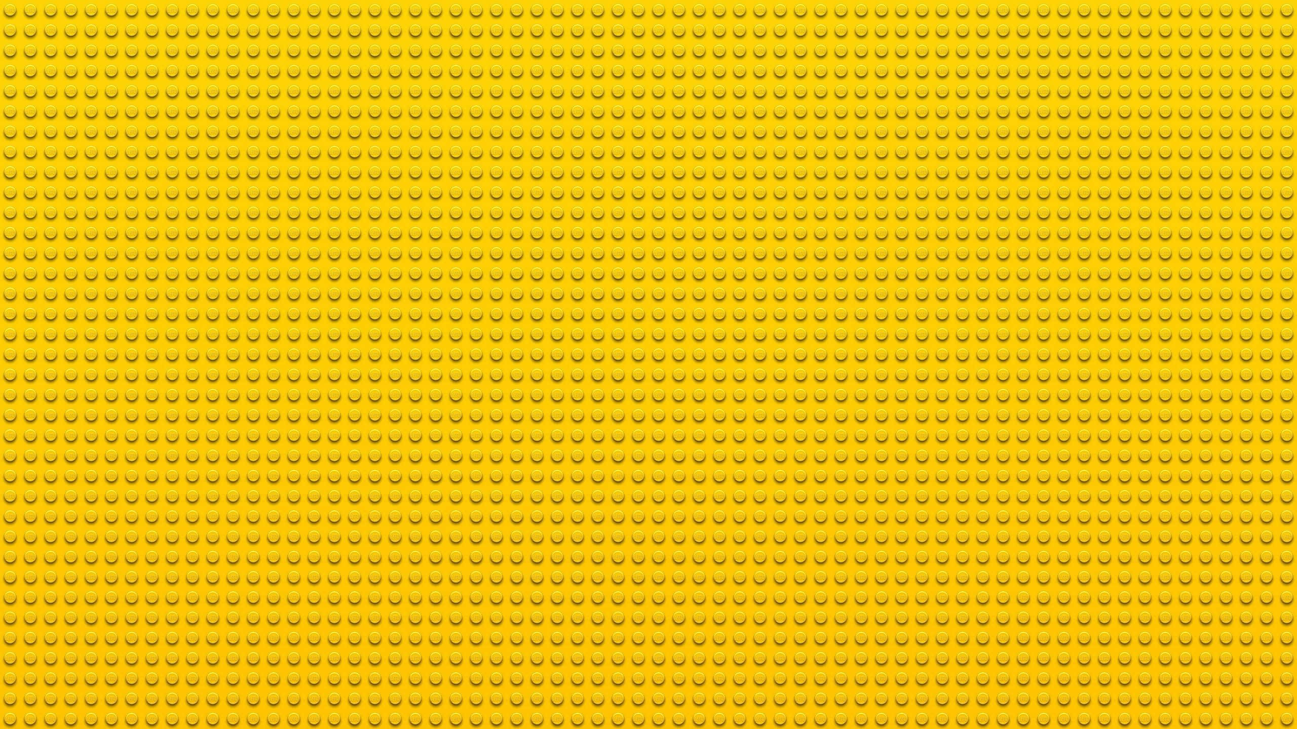 LEGO baseplate, solid yellow, repeating circular studs, 2K Desktop Wallpaper