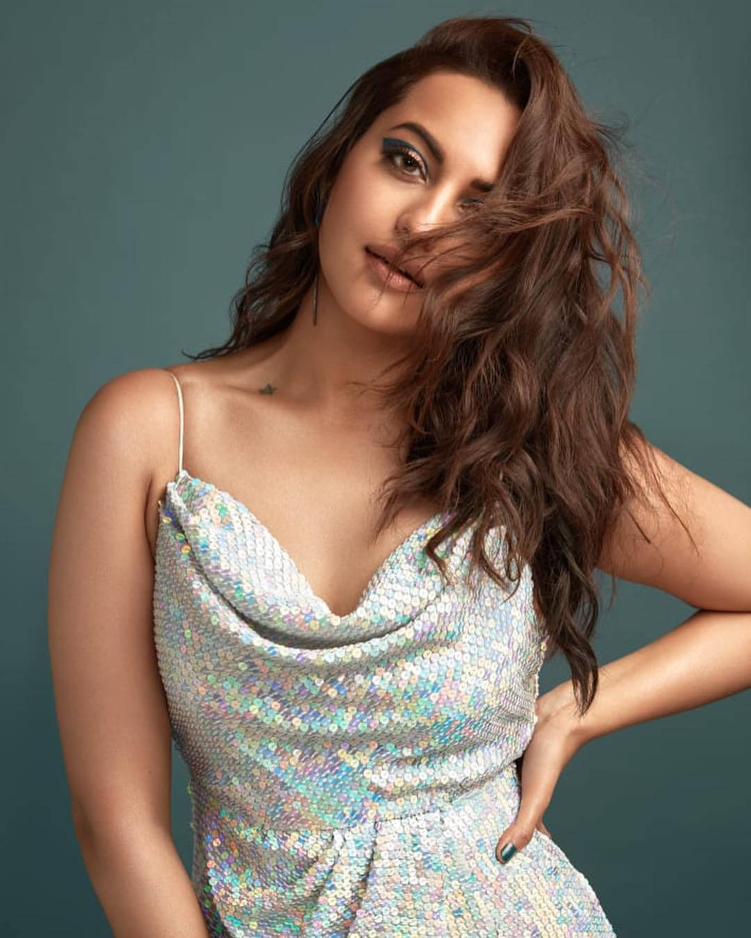 Sonakshi Sinha, shimmering silver sequin dress, muted teal studio backdrop, HD Phone Wallpaper