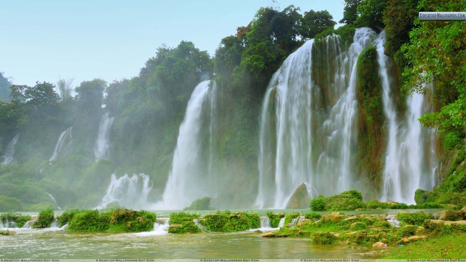 multi-tiered waterfall, lush green jungle foliage, clear blue sky, Full HD Desktop Wallpaper