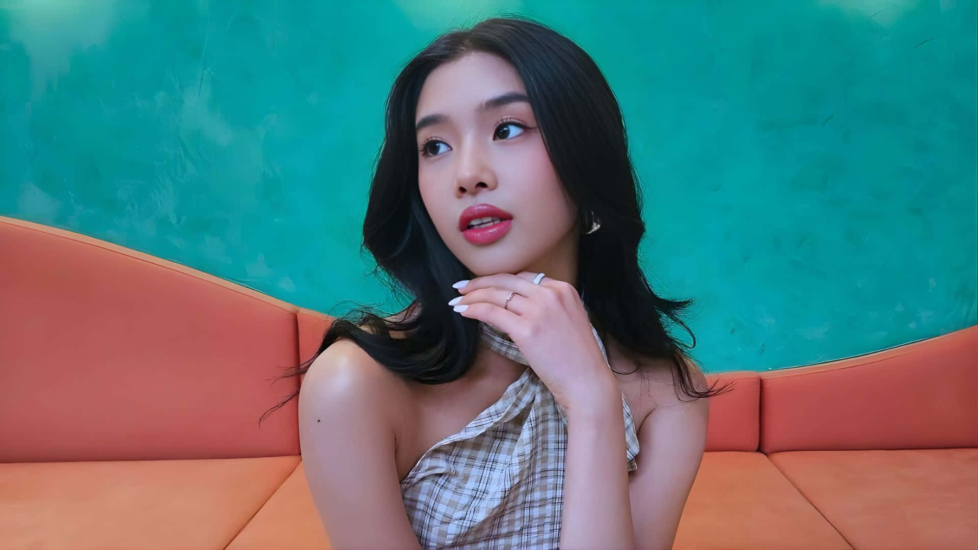 Sophia Katseye, orange couch, teal wall, Full HD Desktop Wallpaper