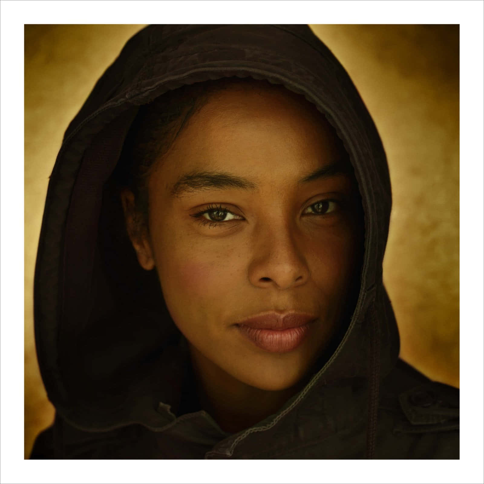 Sophie Okonedo, dark hooded jacket, warm golden textured background, HD Desktop Wallpaper