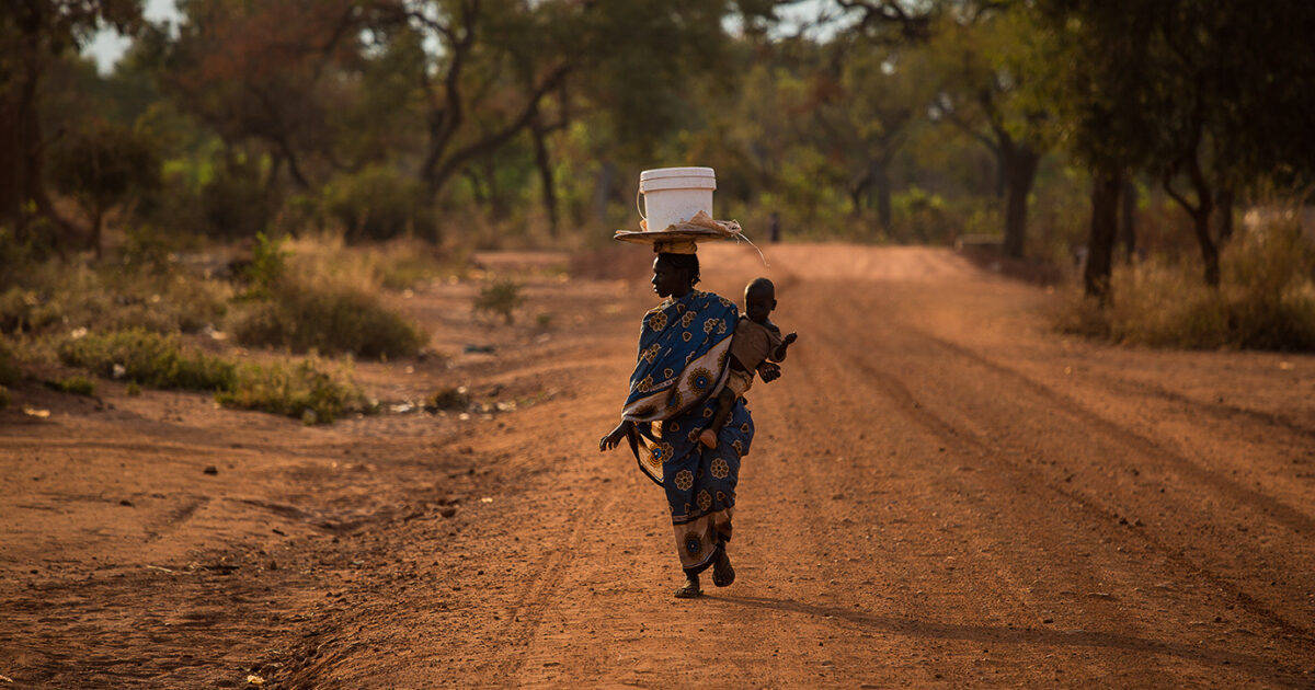 South Sudan, dusty red dirt road, blue patterned dress, SD Desktop Wallpaper