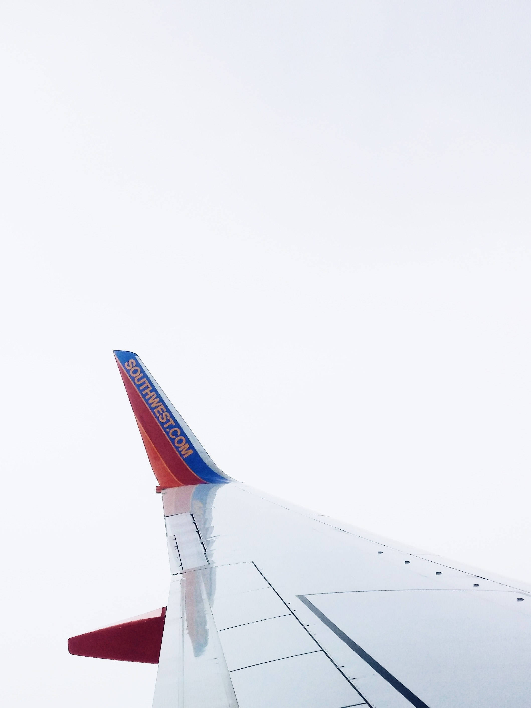 Southwest Airlines, aircraft wing, bright overcast sky, 2K Phone Wallpaper