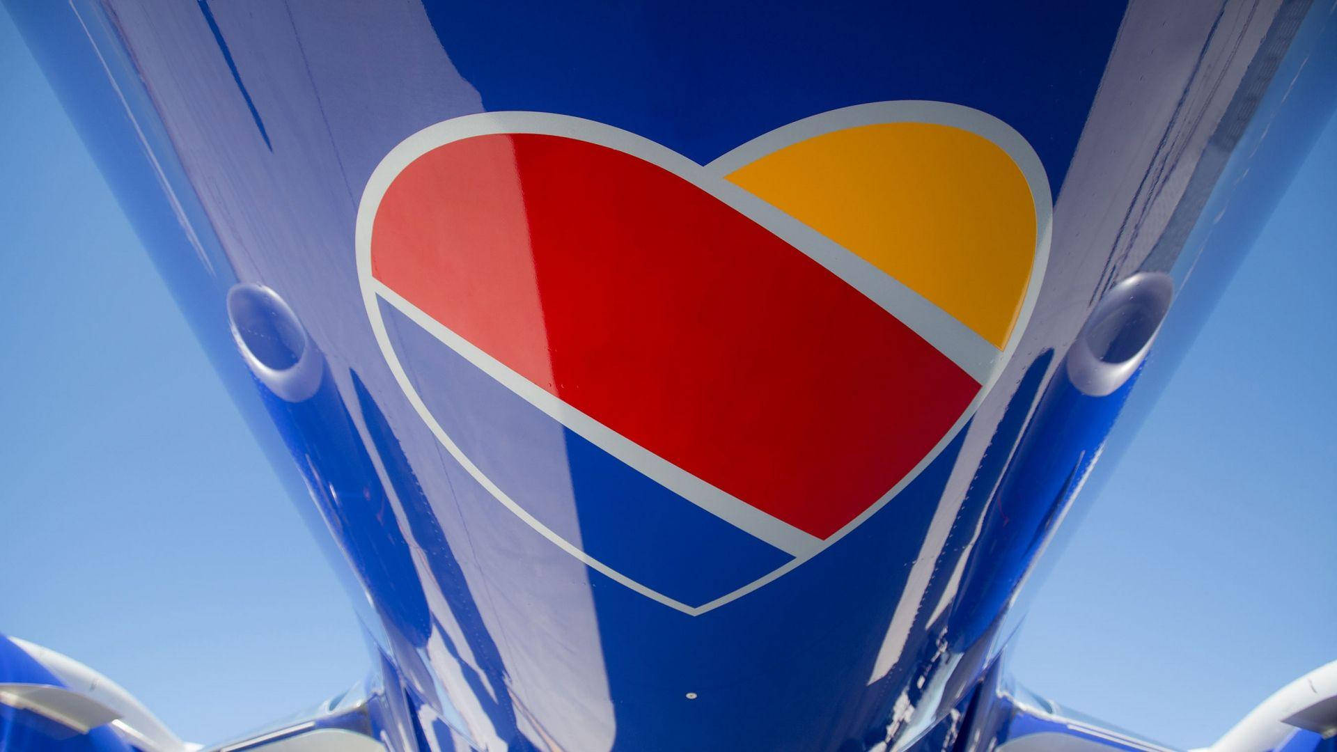 Southwest Airlines, vibrant red yellow and blue heart logo, shiny airplane fuselage, Full HD Desktop Wallpaper