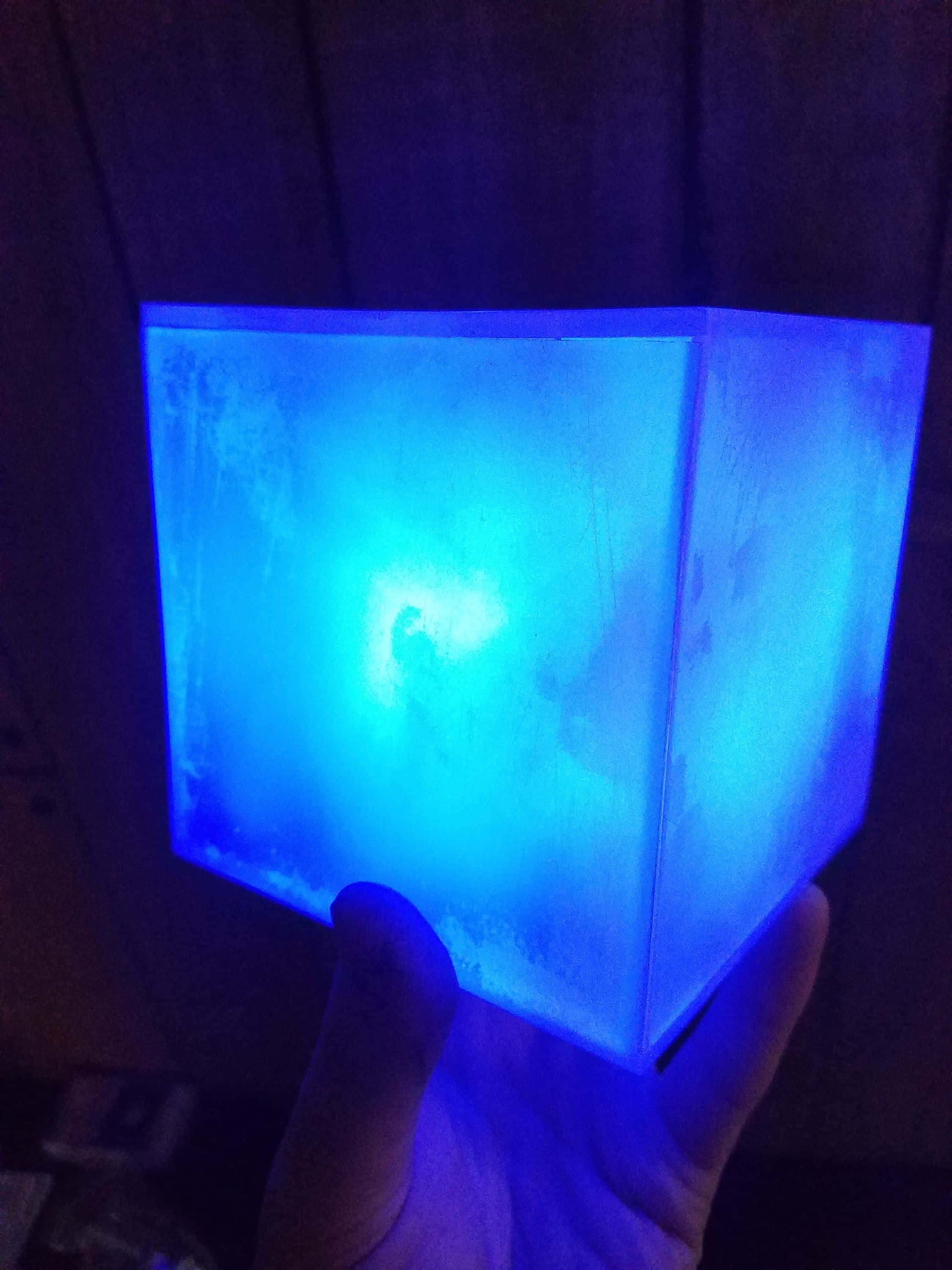 Space Stone, glowing blue translucent cube, dark wooden background, 2K Phone Wallpaper