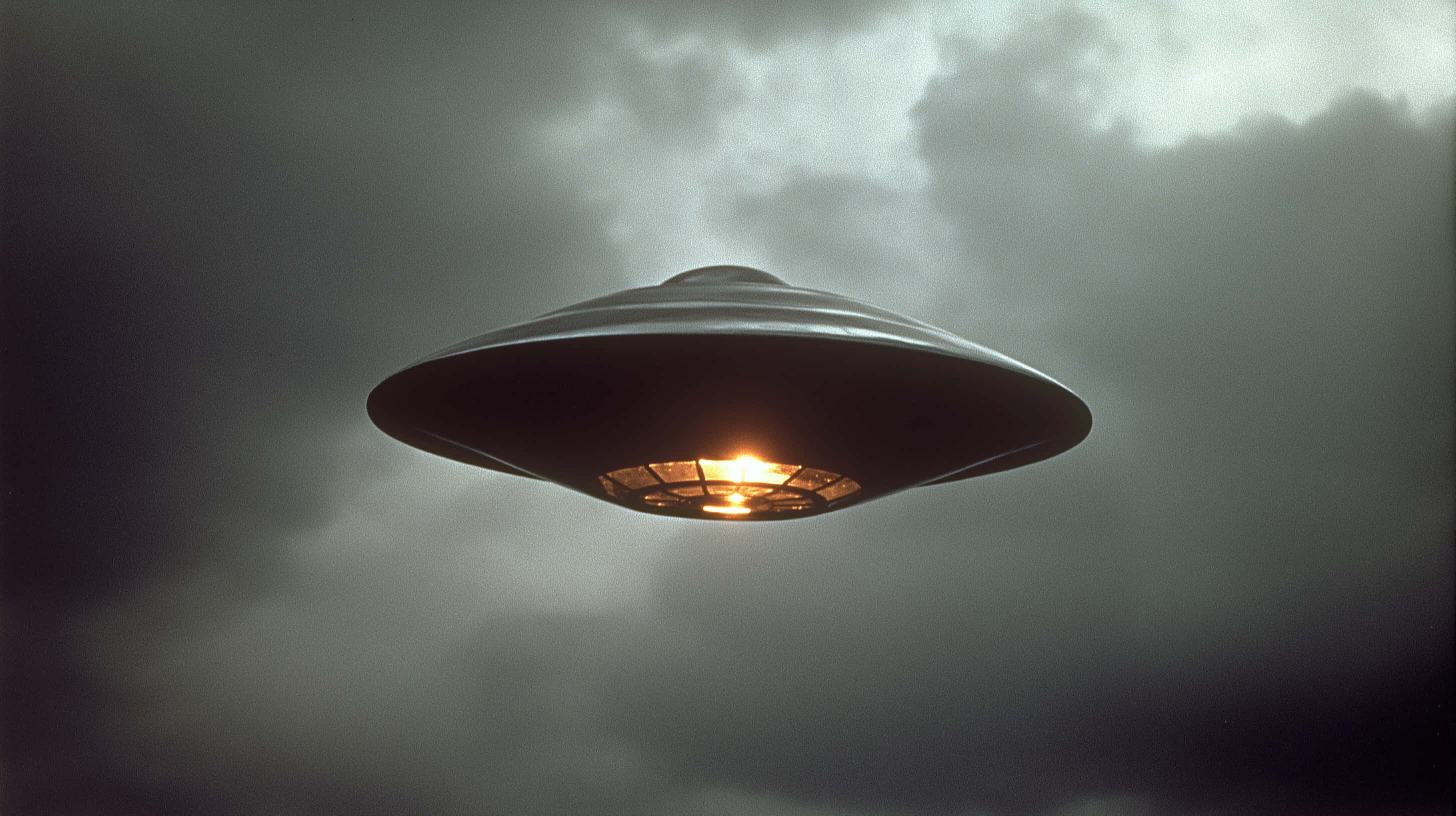 metallic flying saucer, stormy gray sky, glowing orange light, 2K Desktop Wallpaper