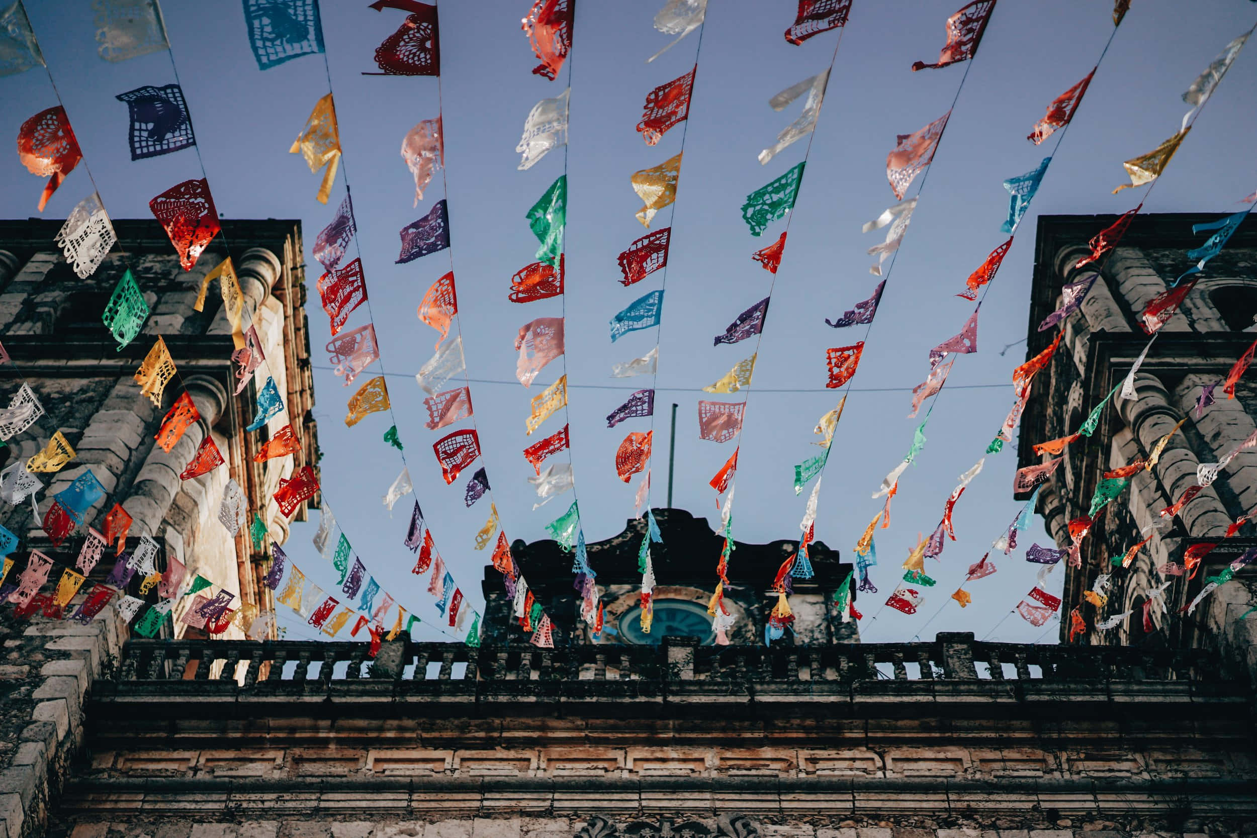 papel picado banners, red yellow green and white, historic stone buildings, Full HD Desktop Wallpaper