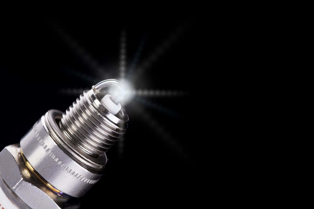 spark plug, glowing, pure black background, SD Desktop Wallpaper