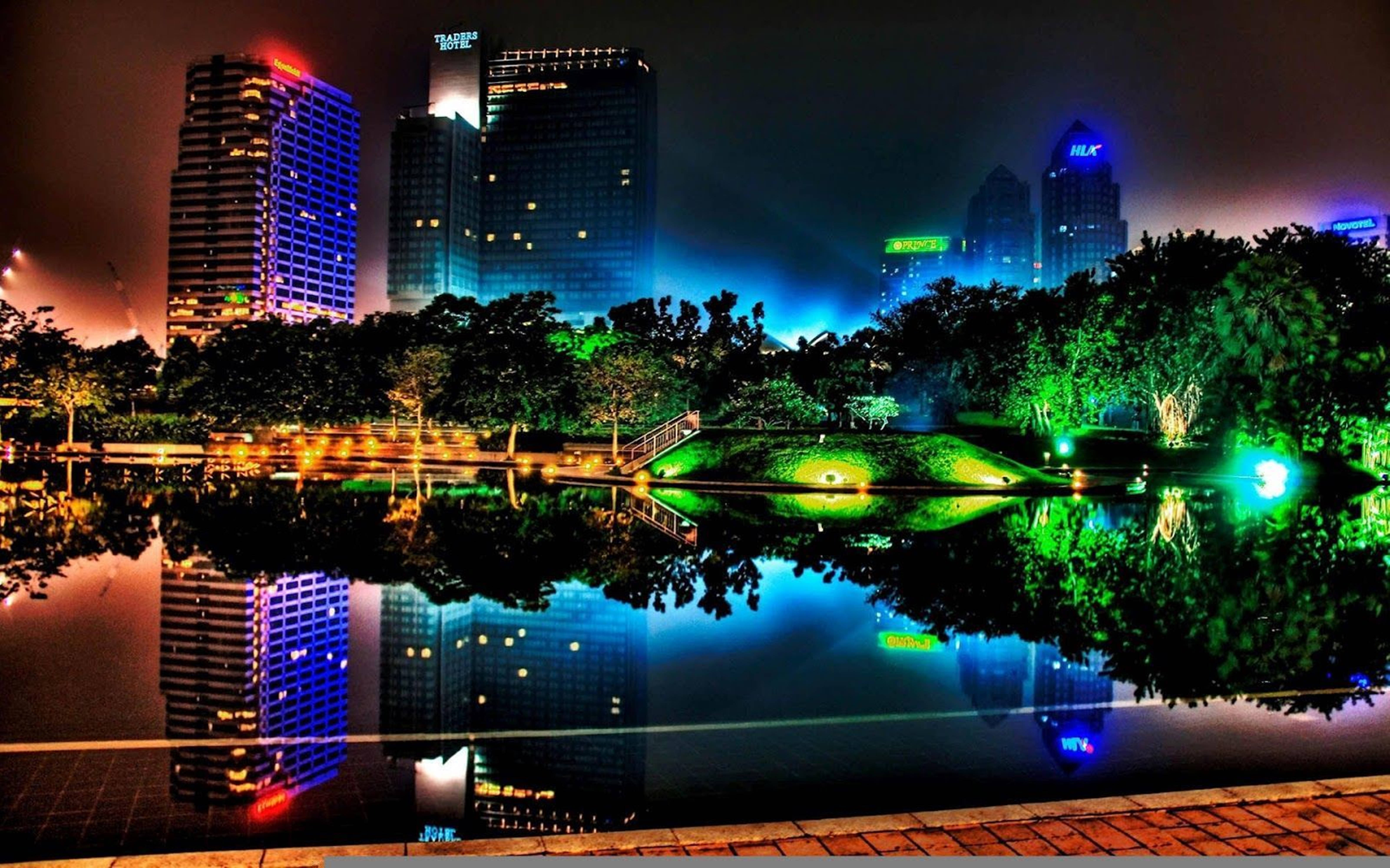 neon-lit skyscrapers, calm pond, glowing green trees, 5K Desktop Wallpaper