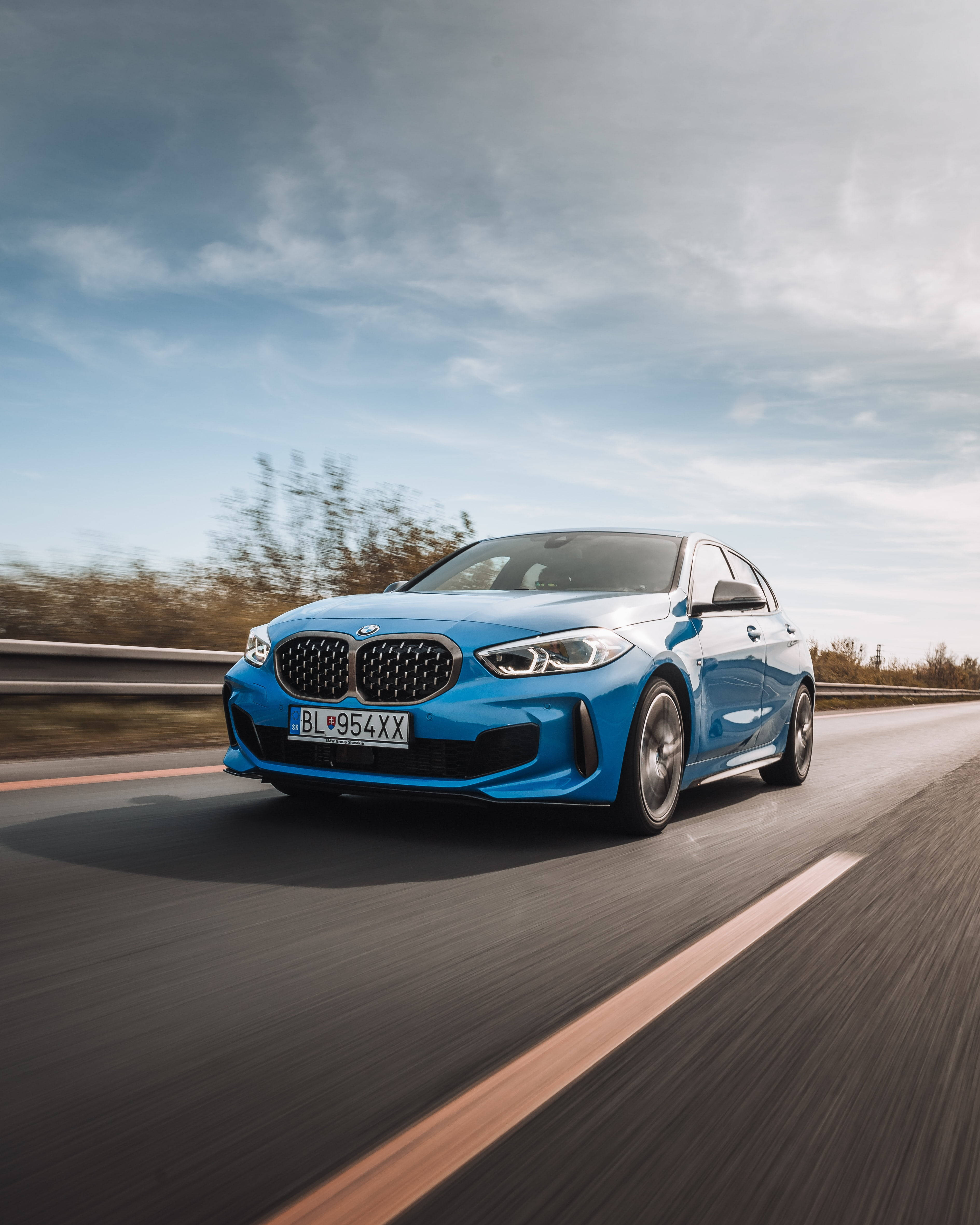 blue BMW sports car, highway, cloudy sky, 4K Phone Wallpaper