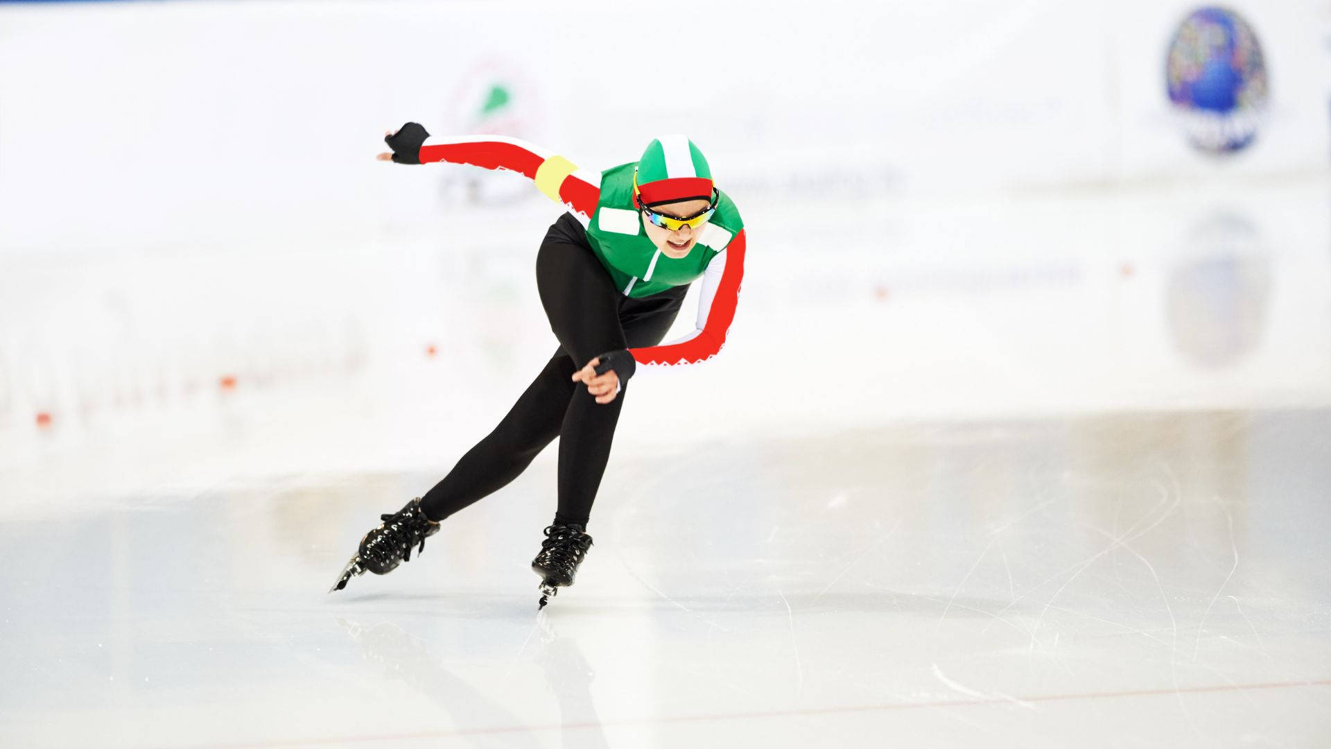 woman speed skating, green red and white gear, bright ice rink, Full HD Desktop Wallpaper