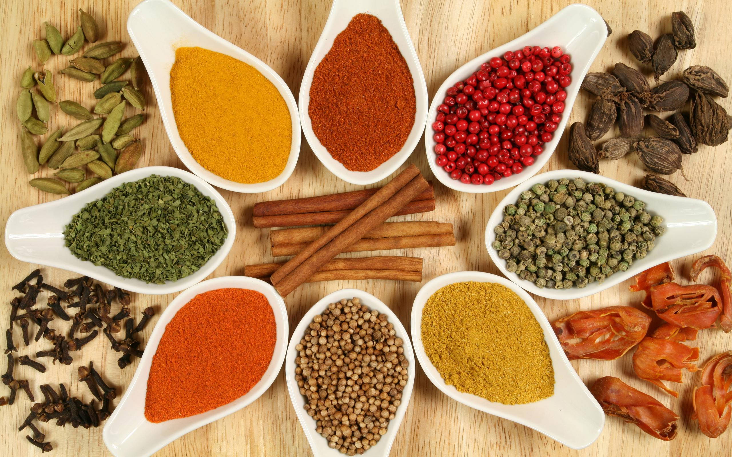 powdered and whole spices, white spoons, wooden surface, 2K Desktop Wallpaper