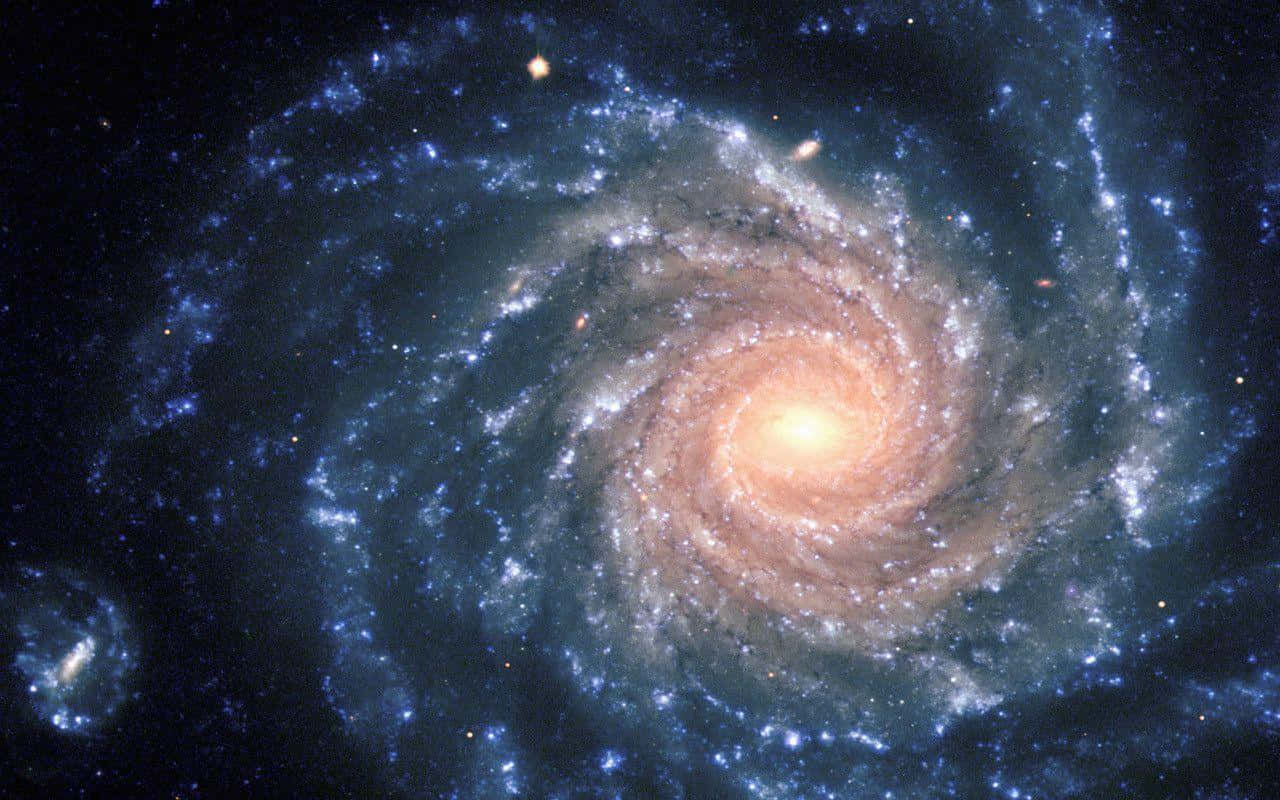 Spiral Galaxy, glowing orange core, swirling blue arms, HD Desktop Wallpaper
