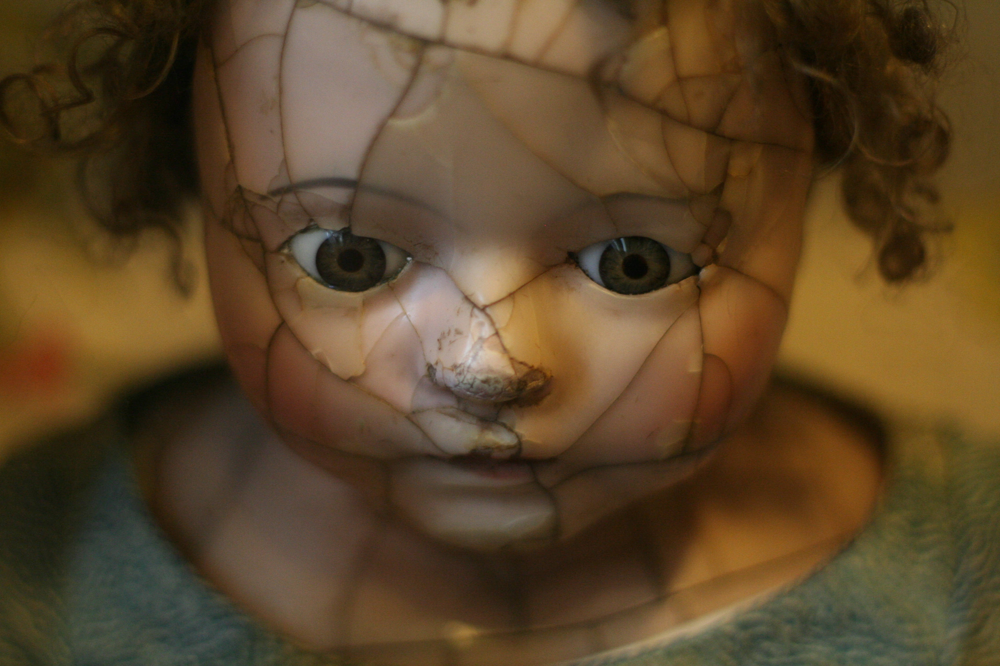 damaged porcelain doll, cracked porcelain doll face, wide haunting eyes, 2K Desktop Wallpaper