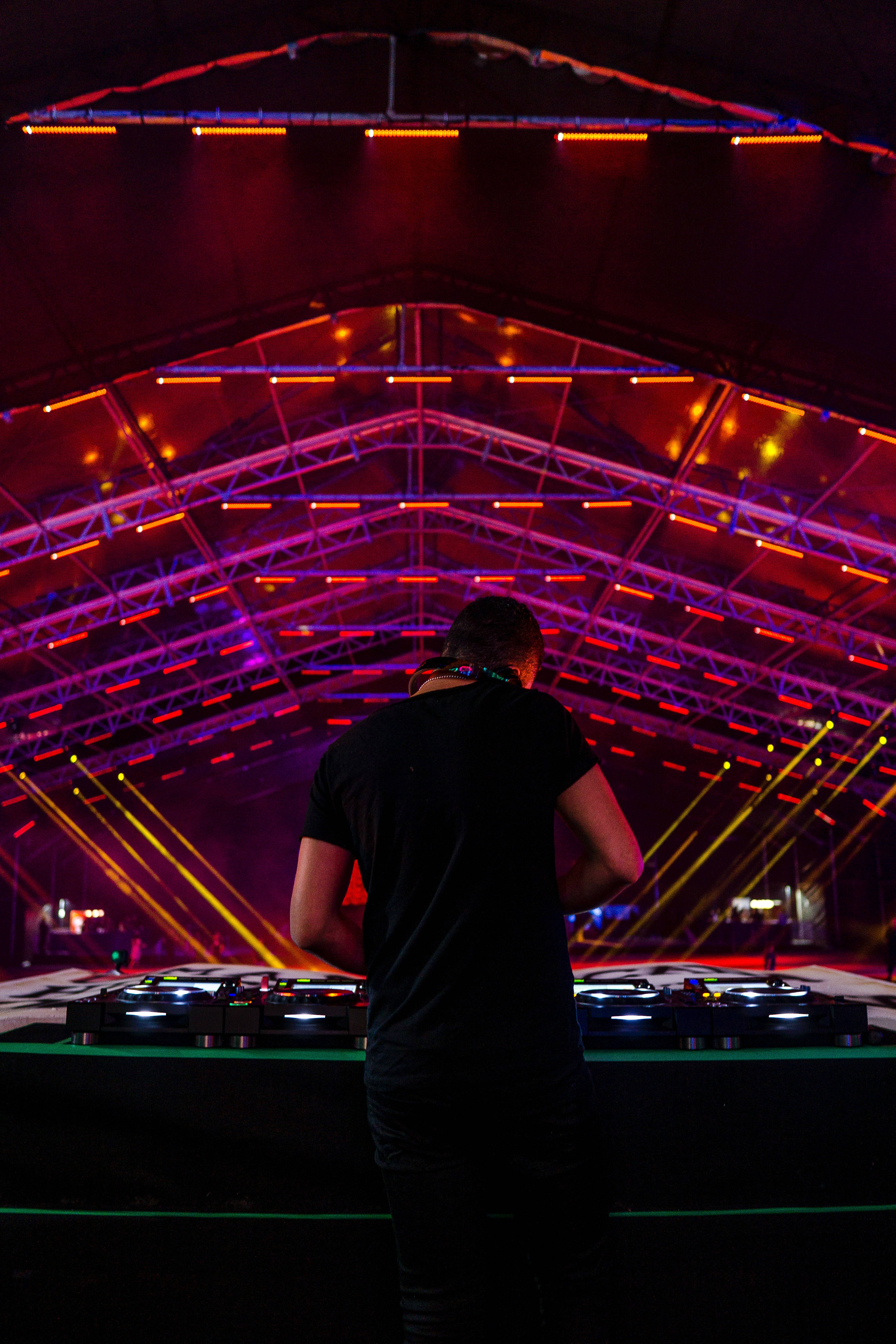 DJ Mixer, neon lights, red and purple laser-lit stage canopy, 5K Phone Wallpaper