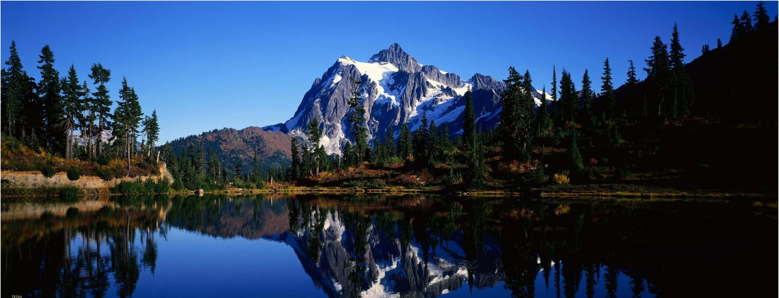 spring dual monitor, snow-capped mountain peaks, calm lake, 2K Desktop Wallpaper