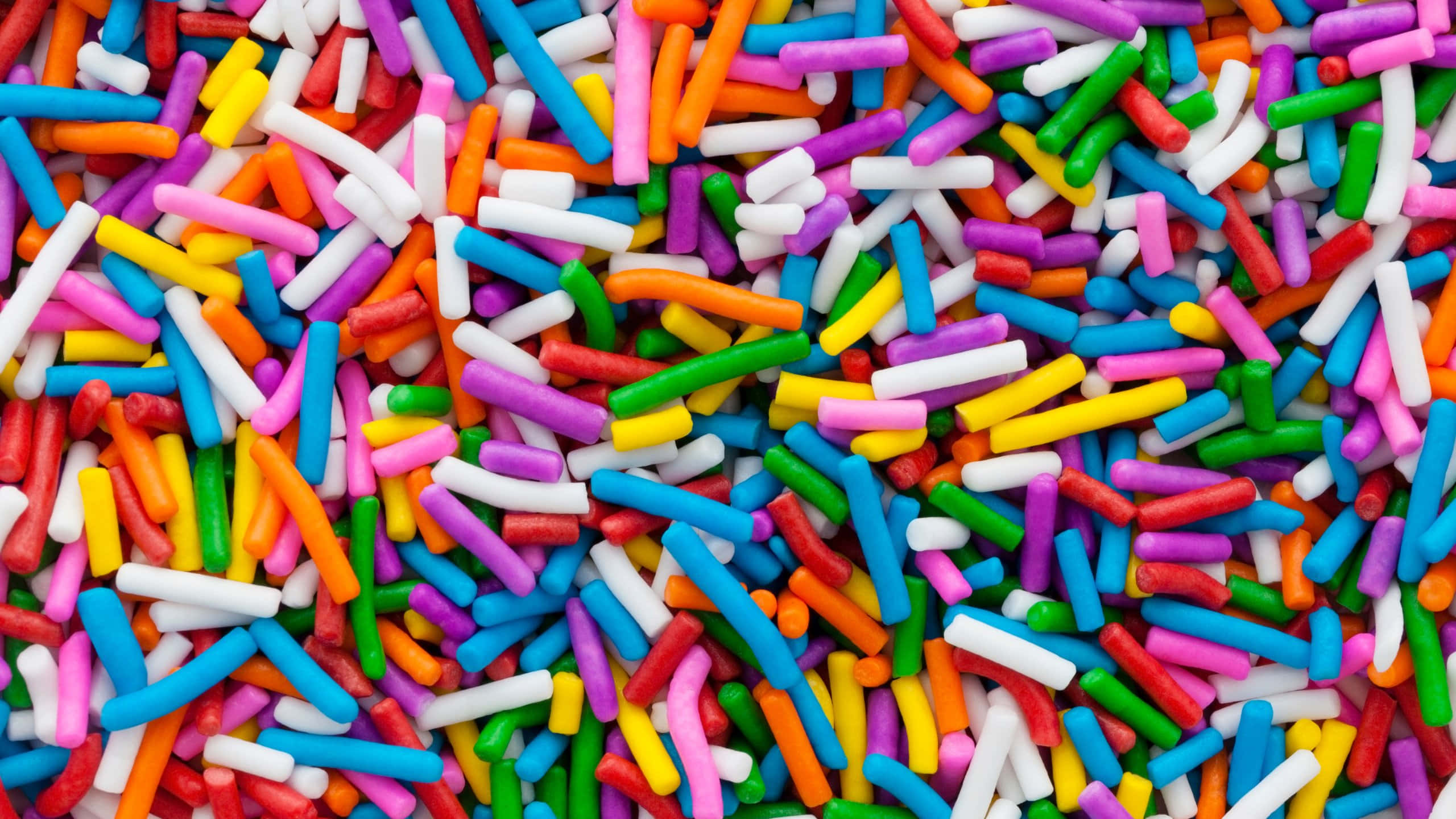 colorful sprinkles, multicolored cylindrical sprinkles, vibrant close-up, 2K Desktop Wallpaper