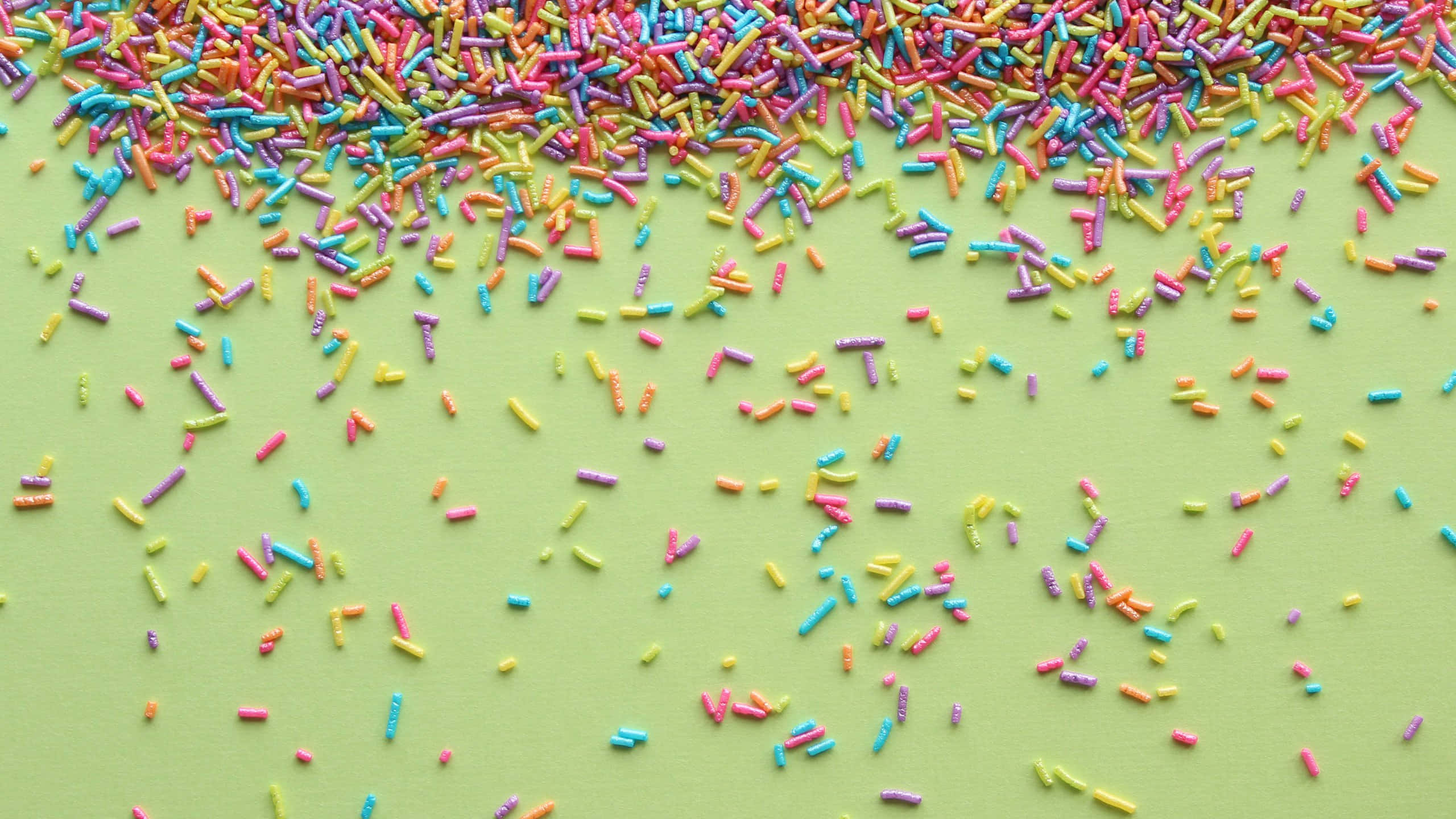 colorful sprinkles, rainbow sprinkles, soft lime green background, 2K Desktop Wallpaper