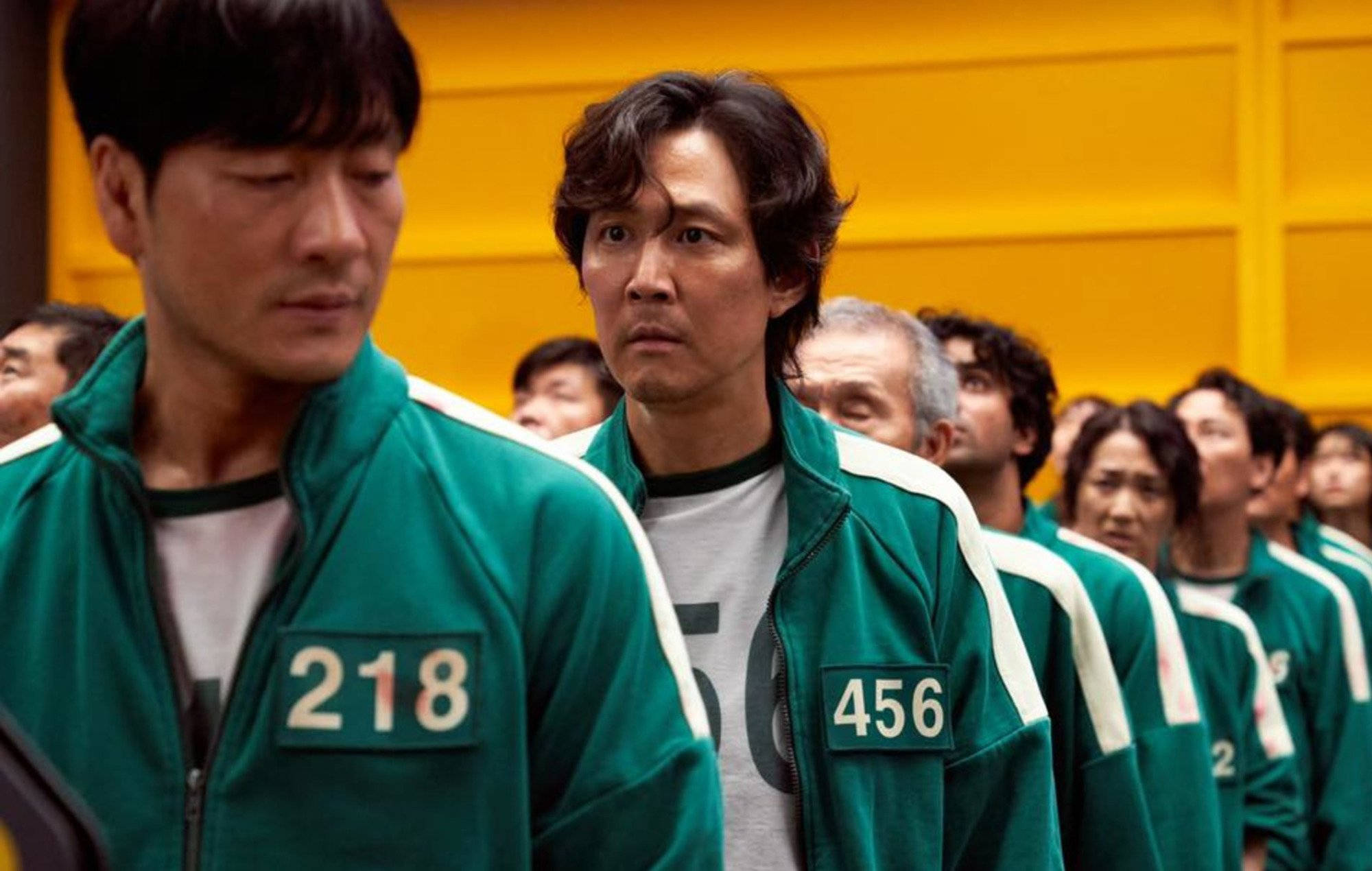 Squid Game, green numbered tracksuits, bright yellow wall, Full HD Desktop Wallpaper