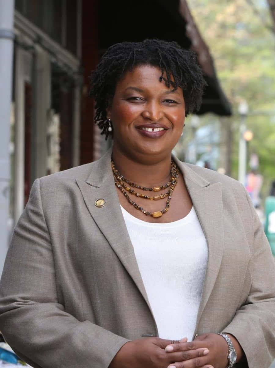 Stacey Abrams, beige blazer, short dreadlocks, SD Phone Wallpaper
