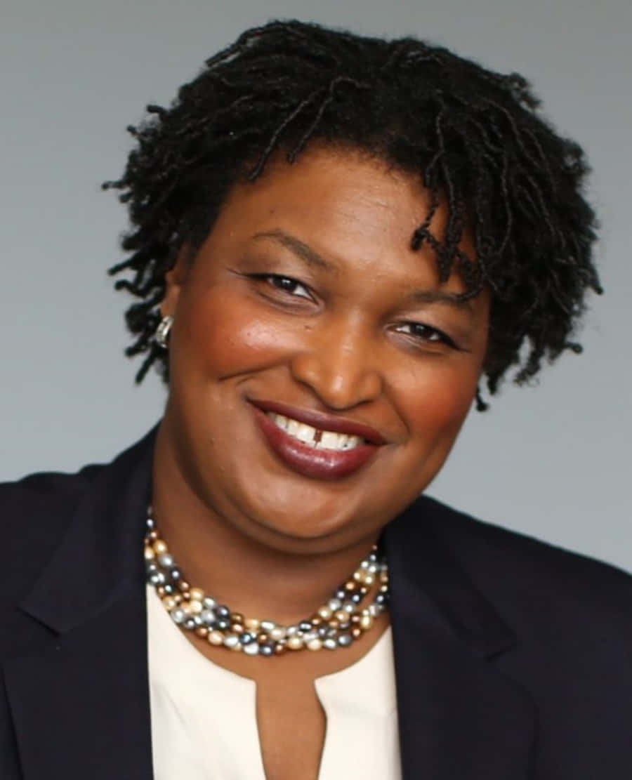 Stacey Abrams, dark blazer, multi-colored pearl necklace, SD Phone Wallpaper
