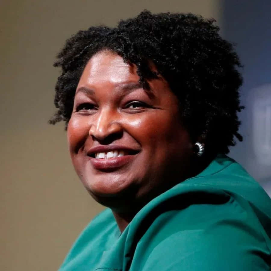 Stacey Abrams, curly black hair, bright green top, SD Desktop Wallpaper