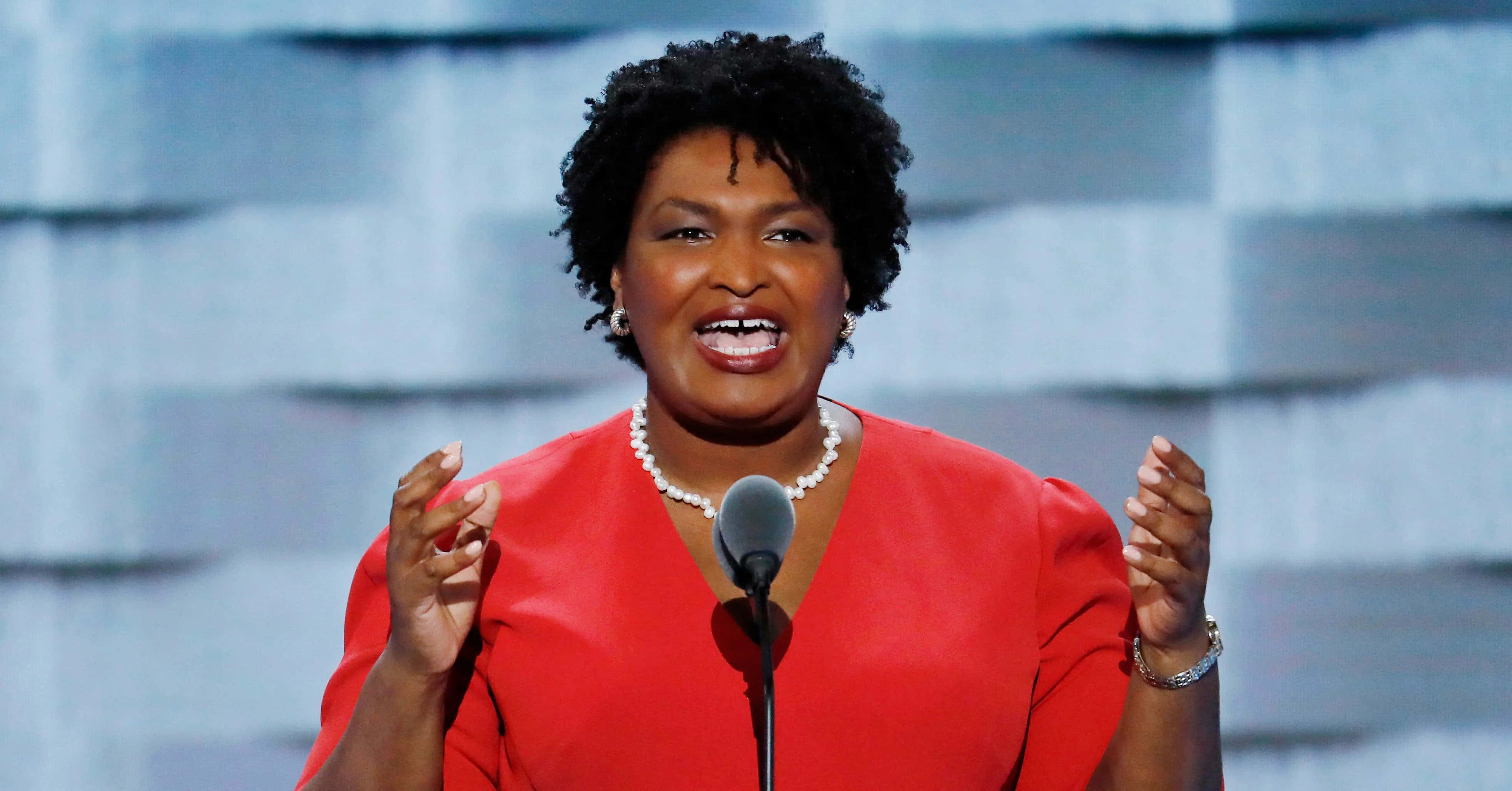 Stacey Abrams, vibrant red dress, microphone, 4K Desktop Wallpaper