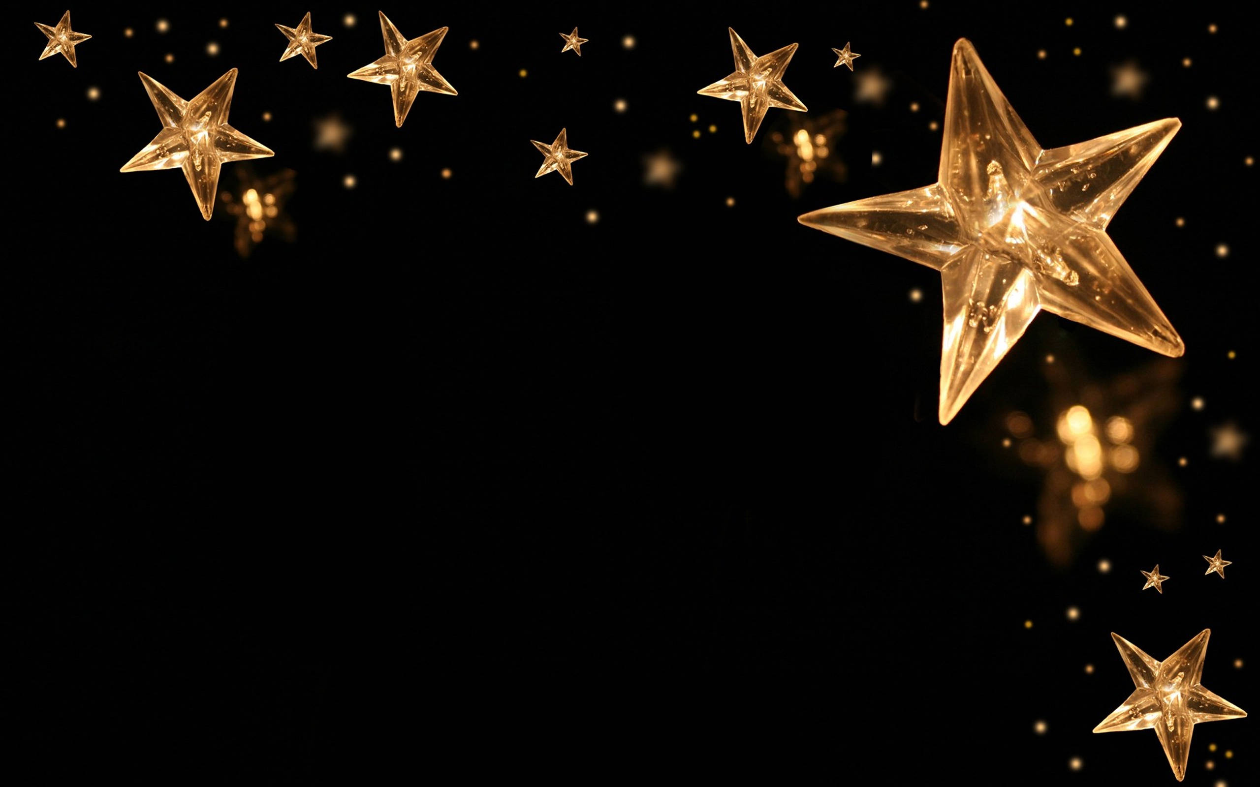 golden star-shaped lights, deep black background, soft bokeh sparkles, 2K Desktop Wallpaper