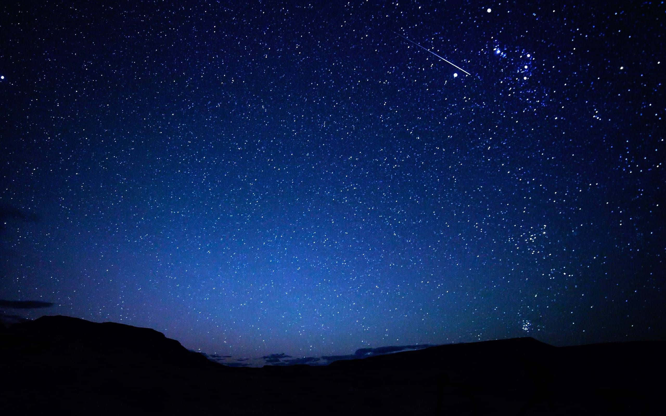 starry night sky, bright meteor, dark mountain silhouettes, 2K Desktop Wallpaper