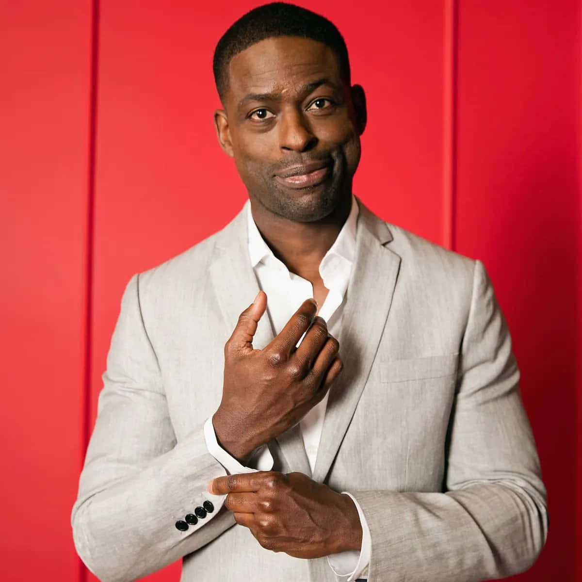 Sterling K Brown, light gray suit, bold red studio backdrop, SD Desktop Wallpaper